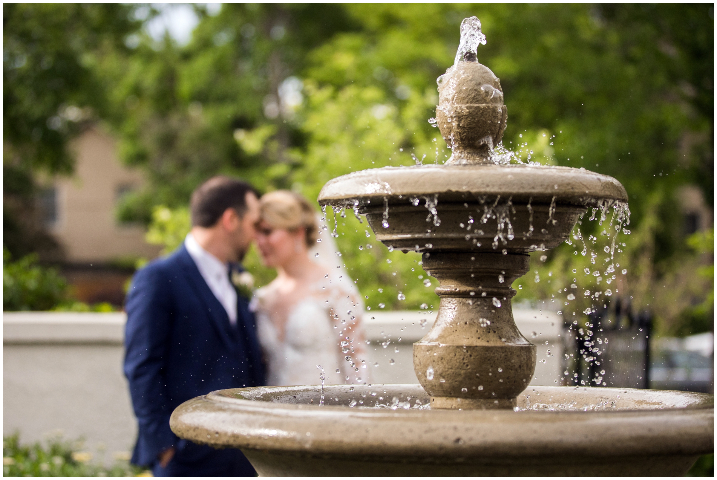 couple posing by a fountain during Cherry Creek Denver wedding portraits 