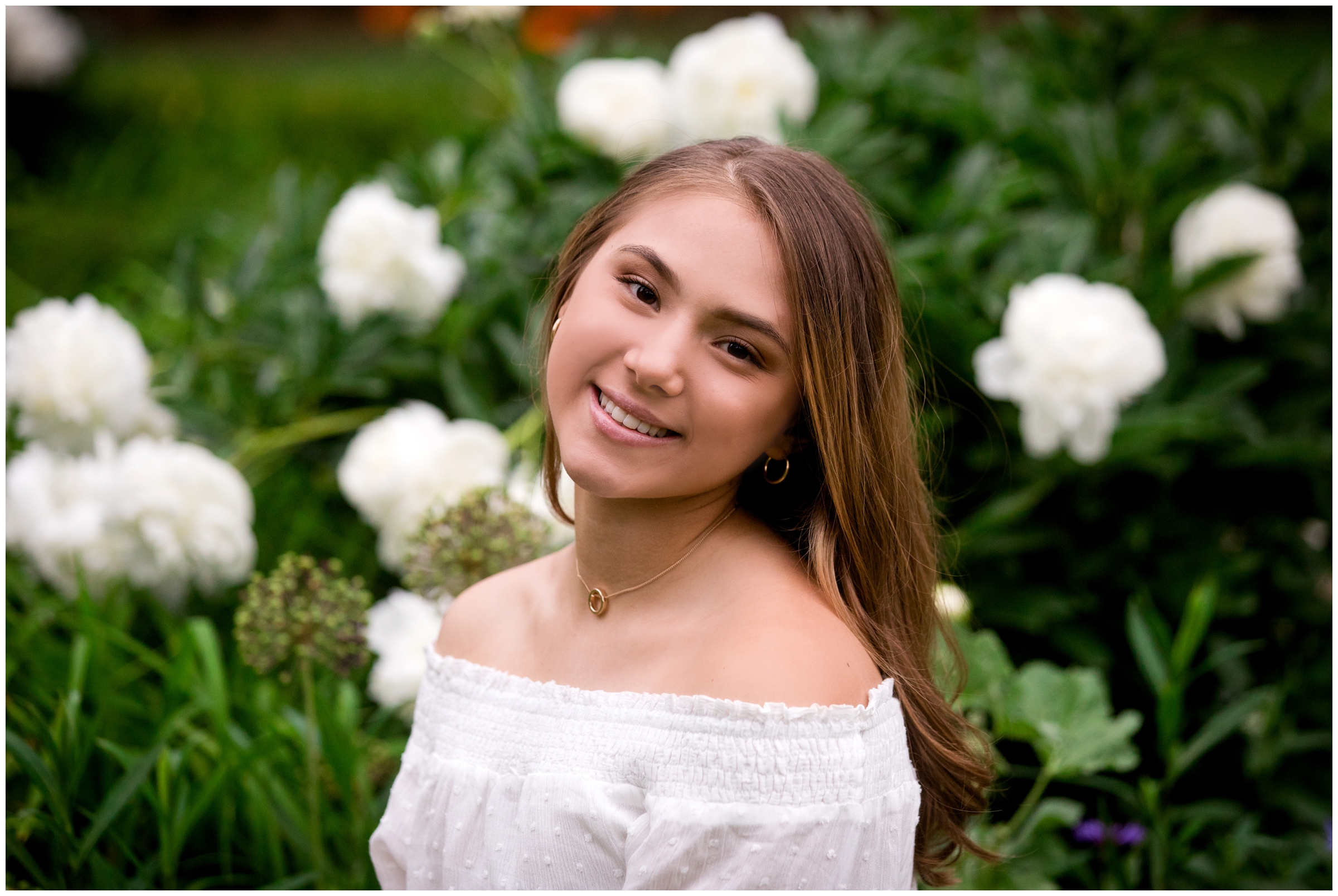teen posing in flower garden during Longmont senior pictures 