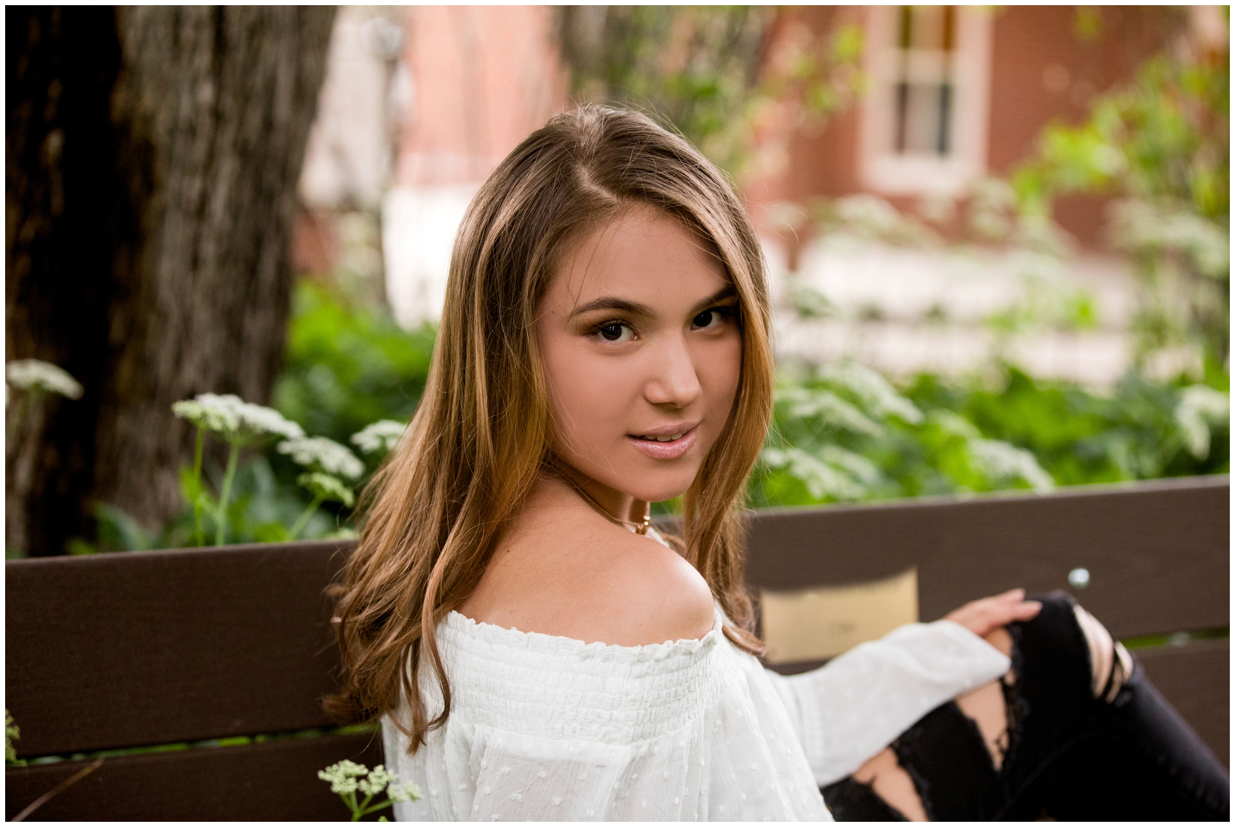 teen girl posing on a bench during Colorado garden senior portraits 