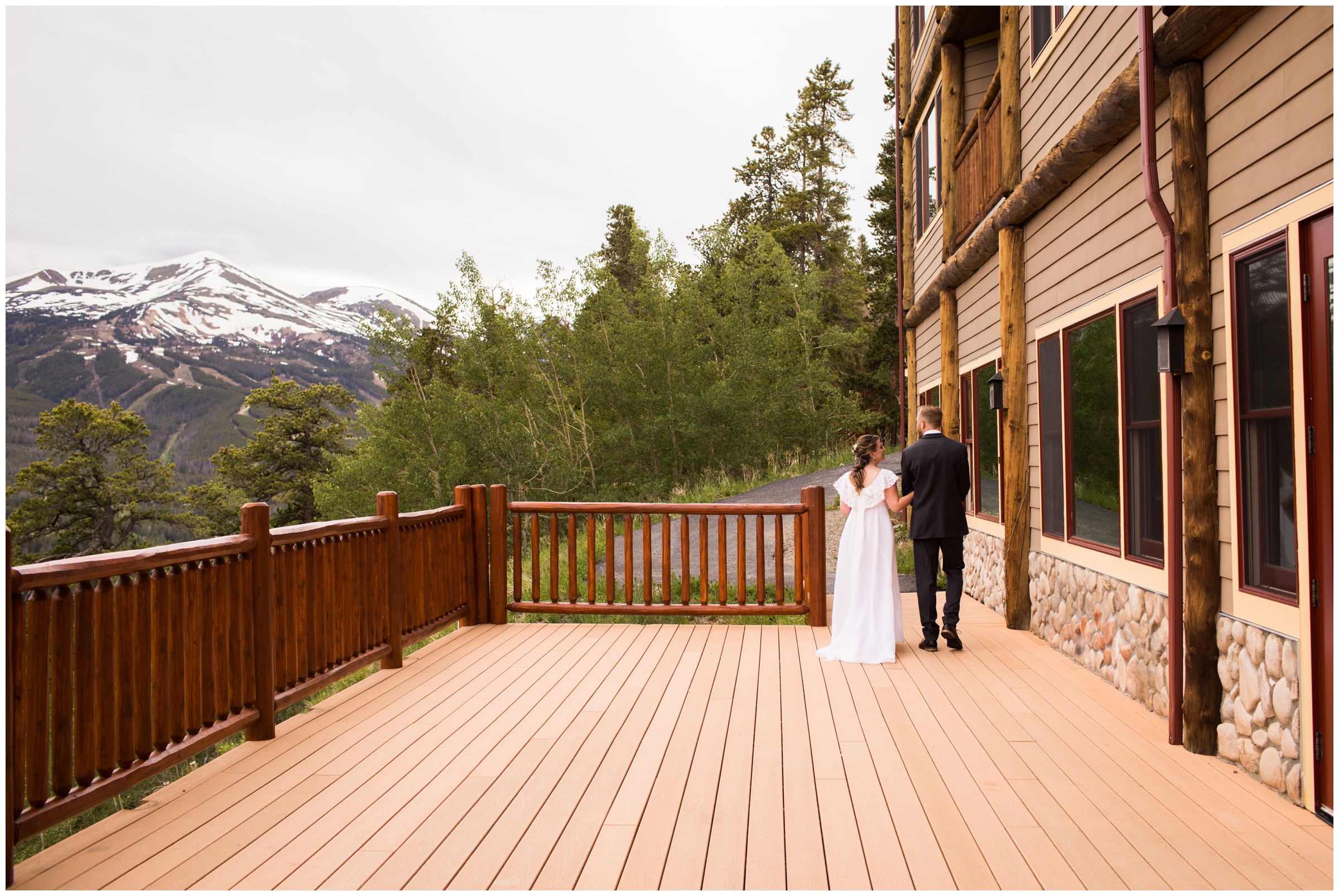 candid photo of bride and groom walking on Lodge at Breckenridge deck 