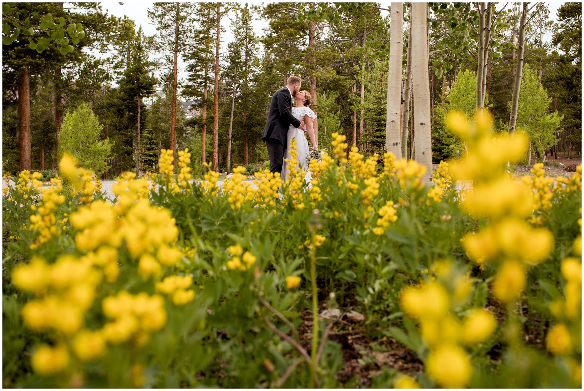 bride and groom kissing amongst wildflowers at the Lodge at Breckenridge wedding photos by Breckenridge Colorado photographer Plum Pretty Photography