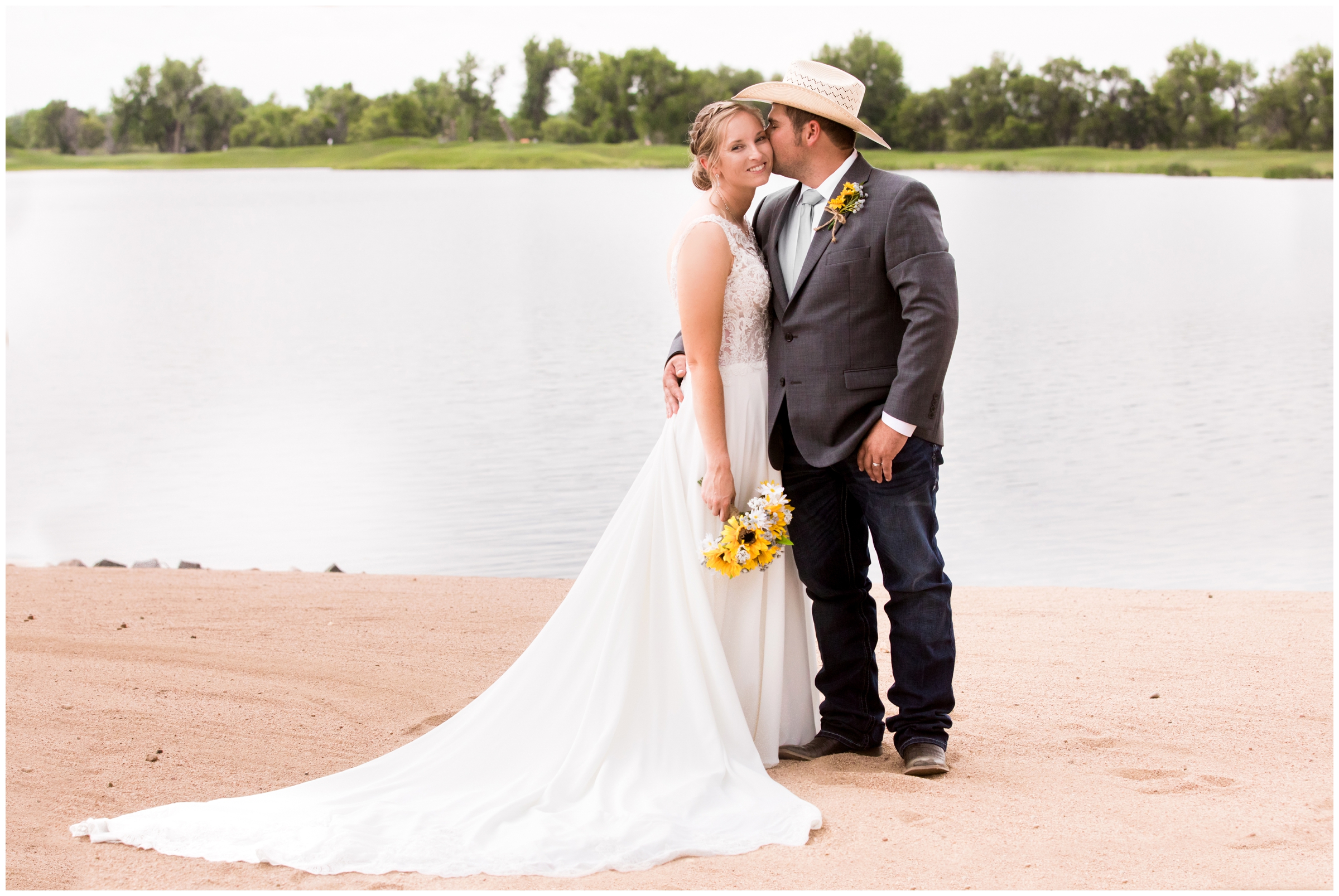 couple kissing on the beach at Pelican Lakes golf course wedding in Windsor Colorado 