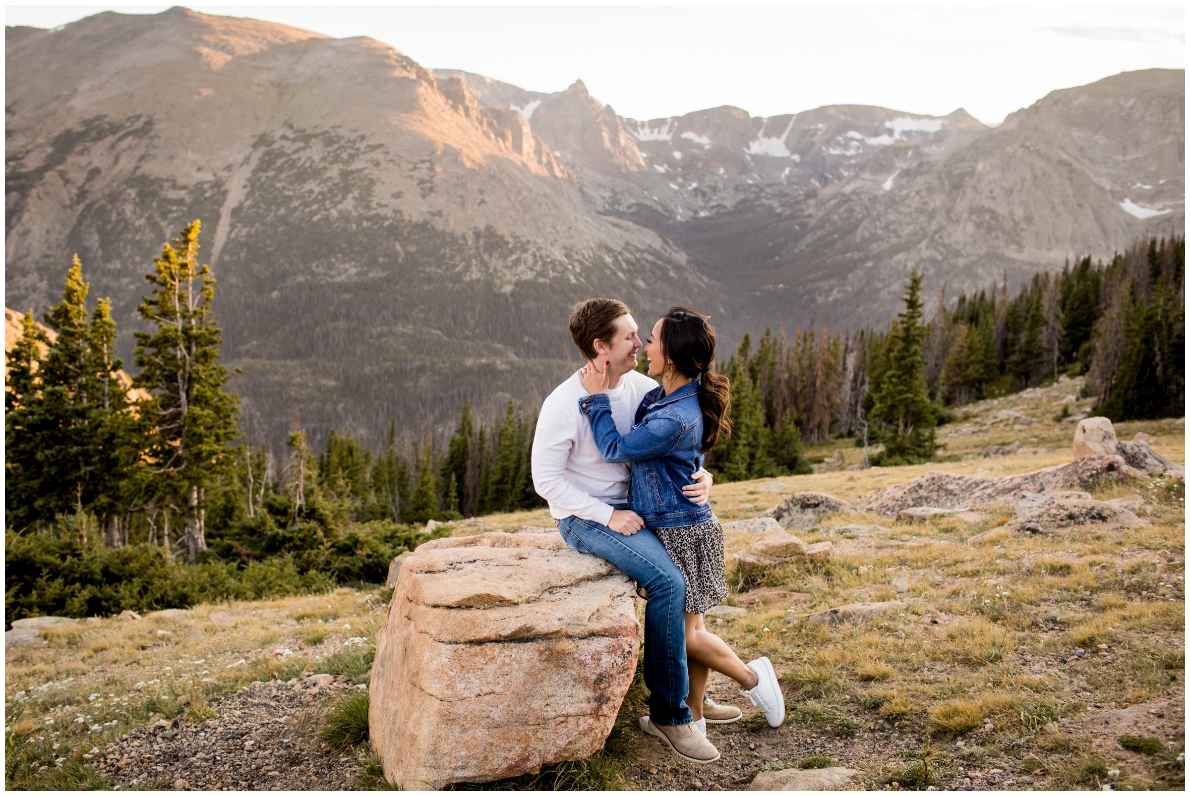 couple cuddling on a rock during RMNP Colorado mountain engagement pictures