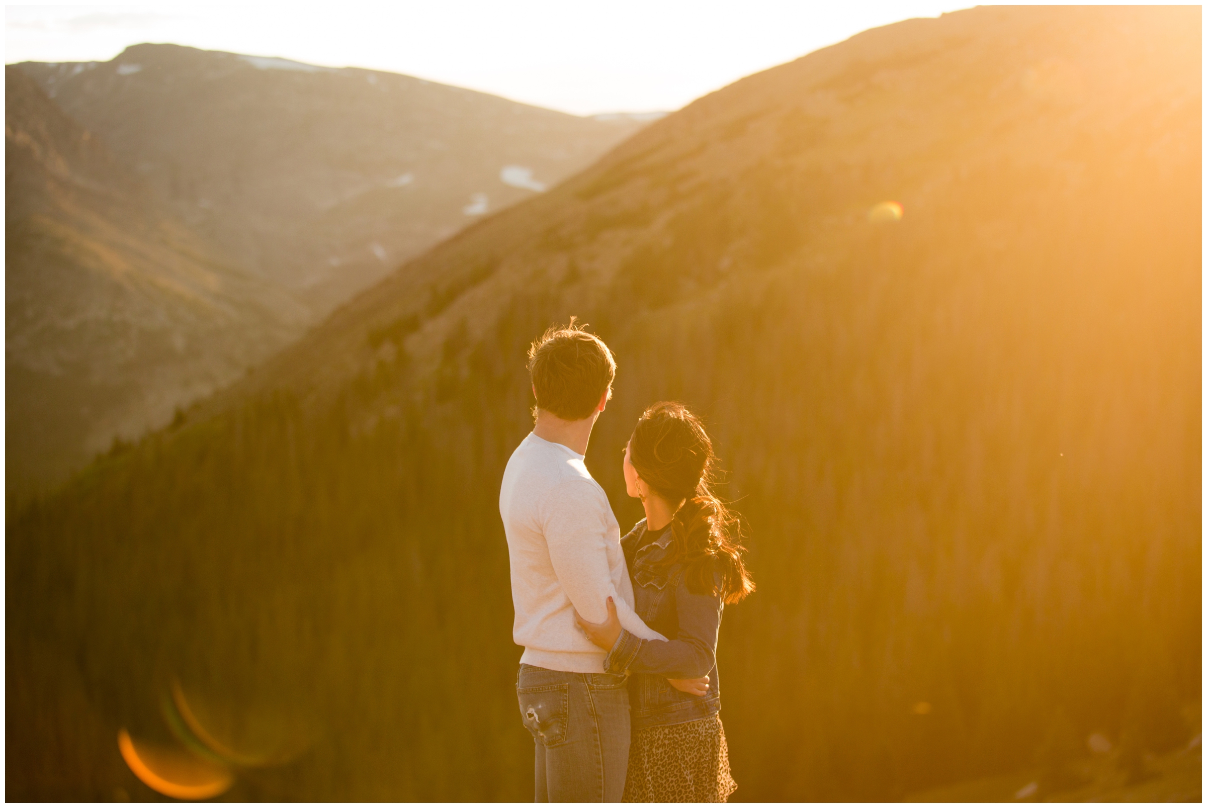 couple on the edge of the mountain for Estes Park Colorado engagement pictures 