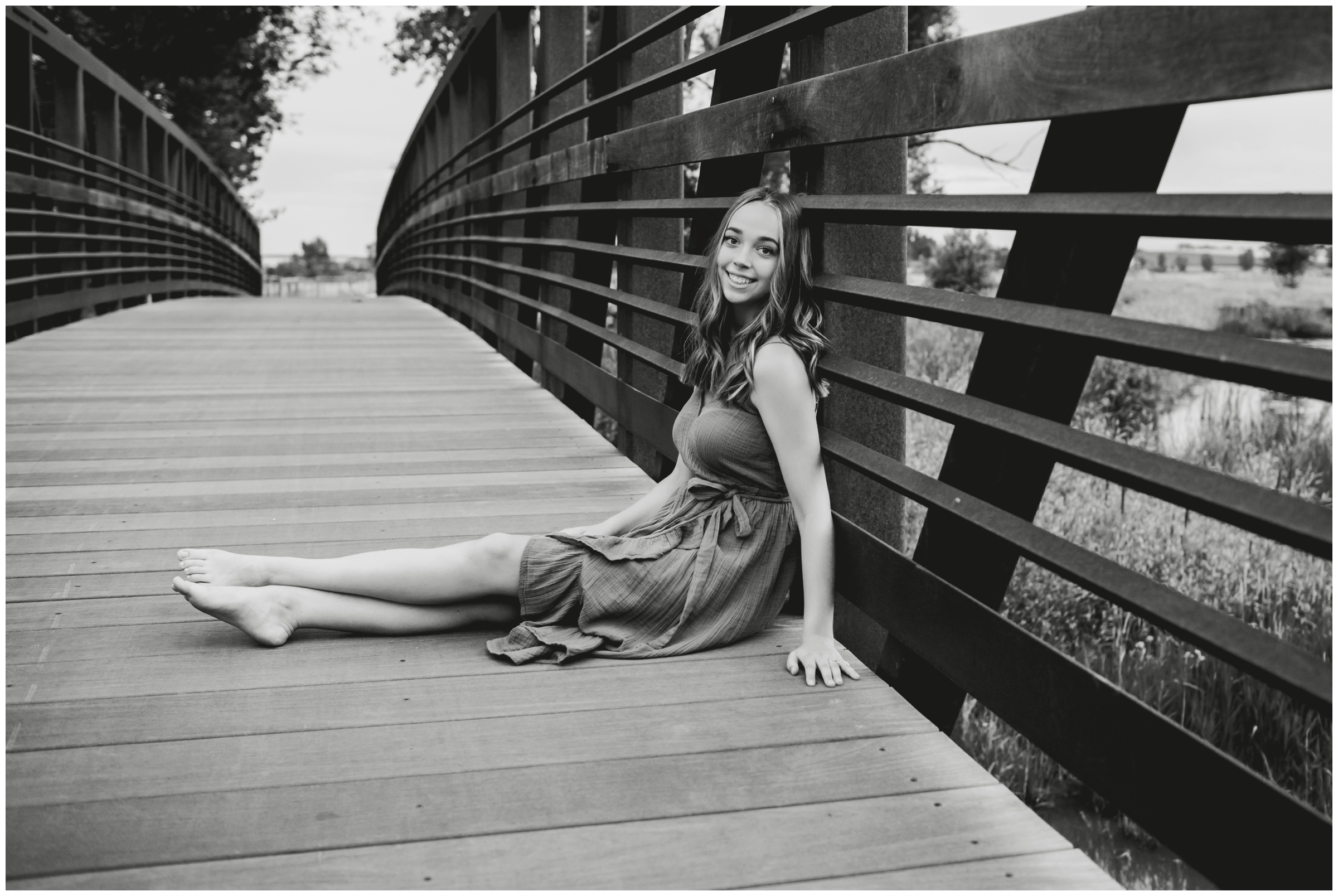 teen sitting on bridge Skyline High School Longmont senior photography session 