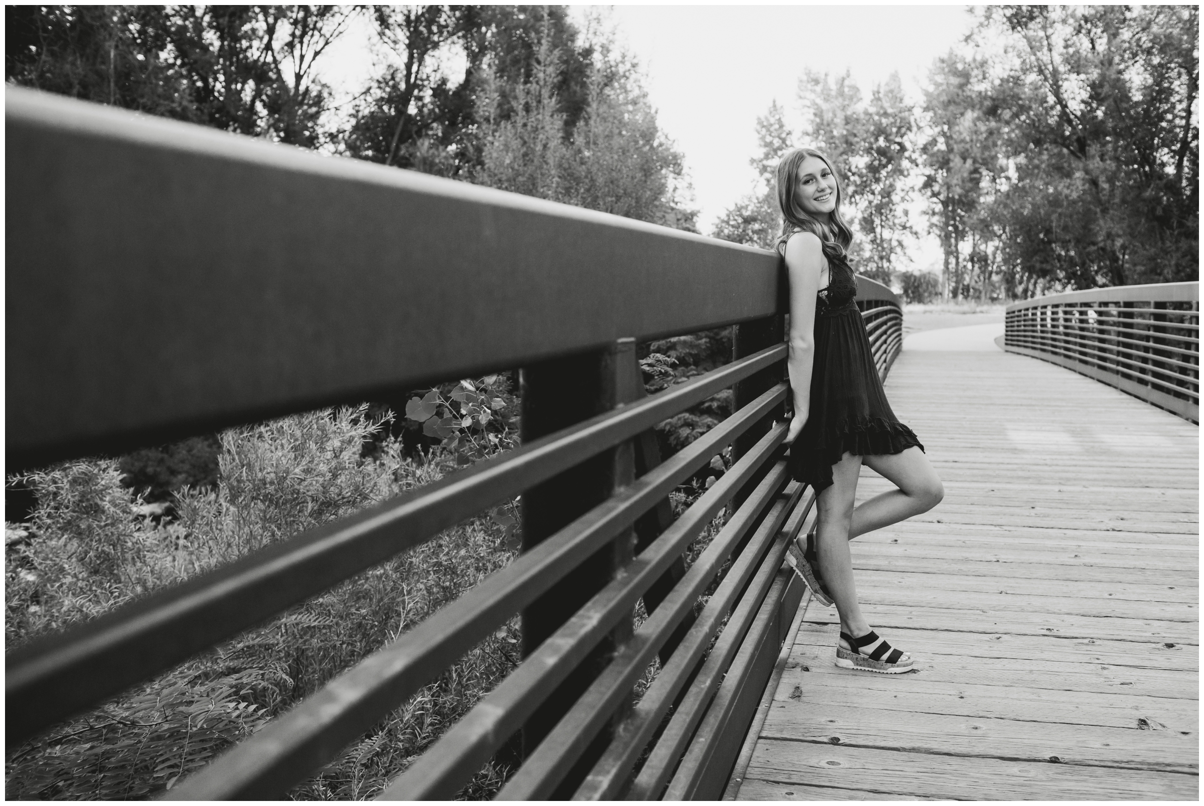 teen girl leaning against bridge during Golden Ponds Longmont senior photos 