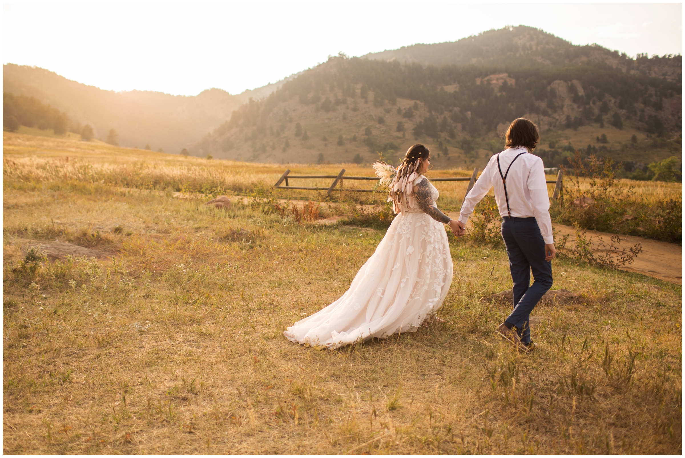 couple walking through field during Boulder Colorado elopement wedding at Chautauqua