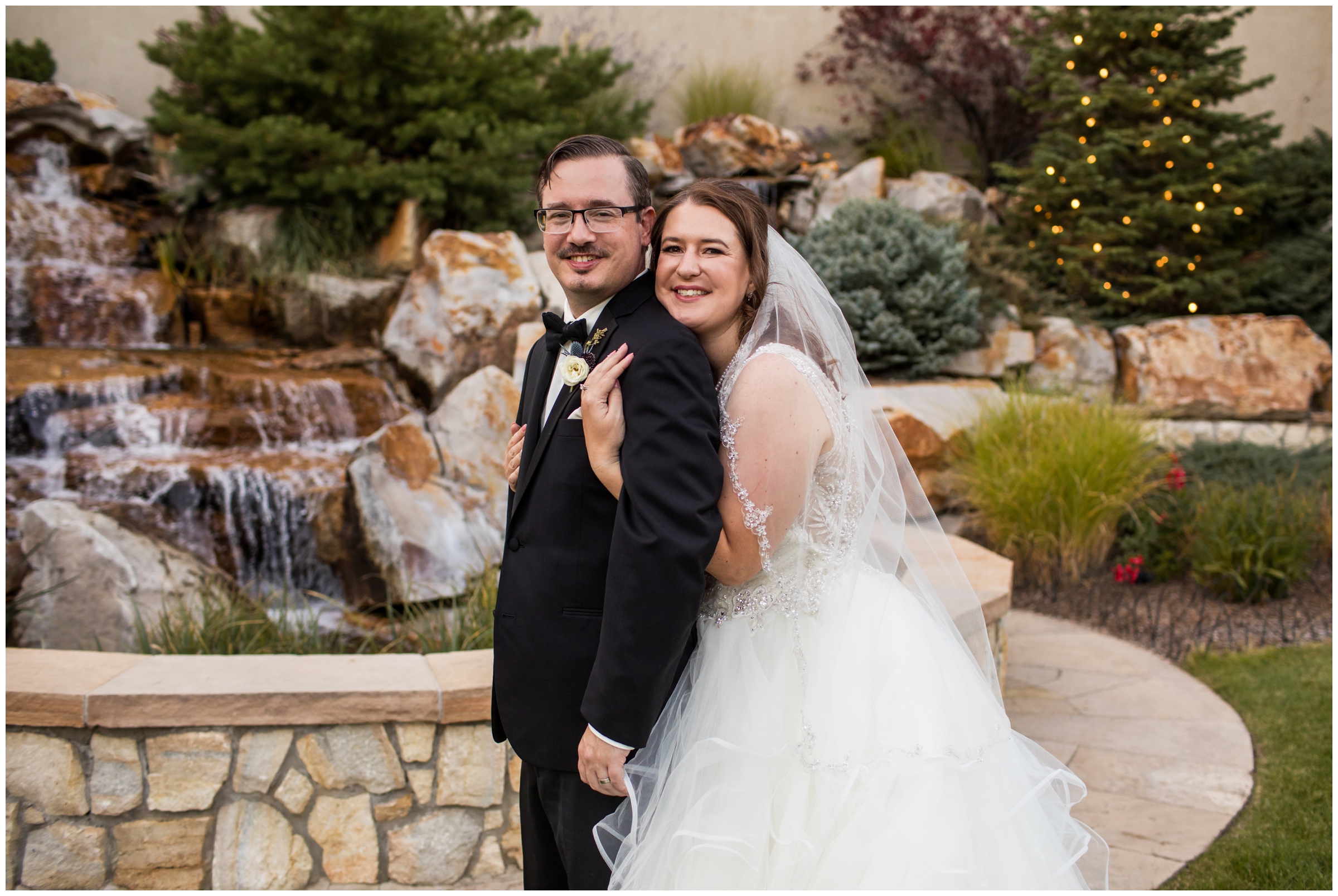 bride and groom posing in front of water feature during Cielo at Castle Pines wedding portraits 