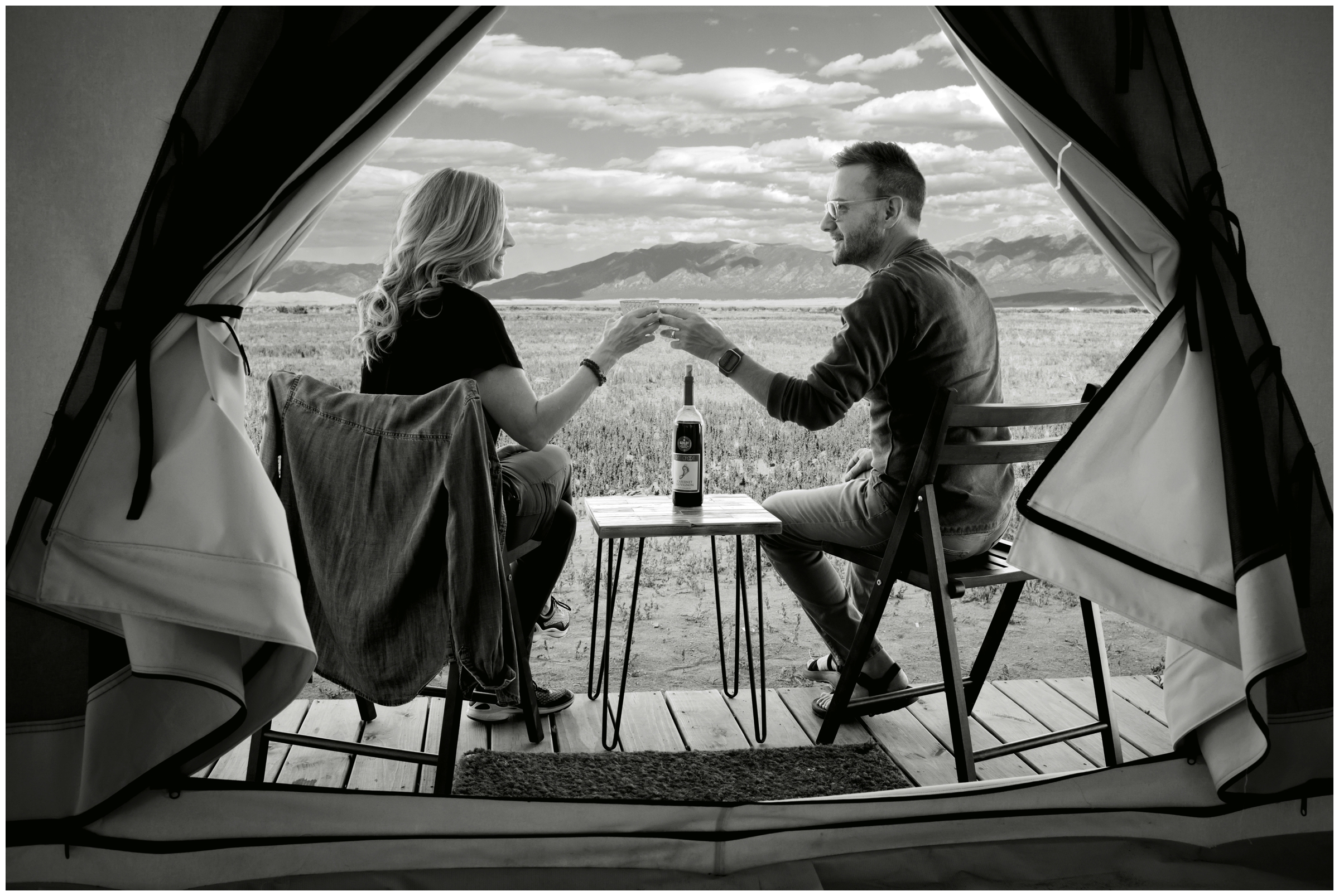 couple toasting wine during Colorado couple's anniversary photography session