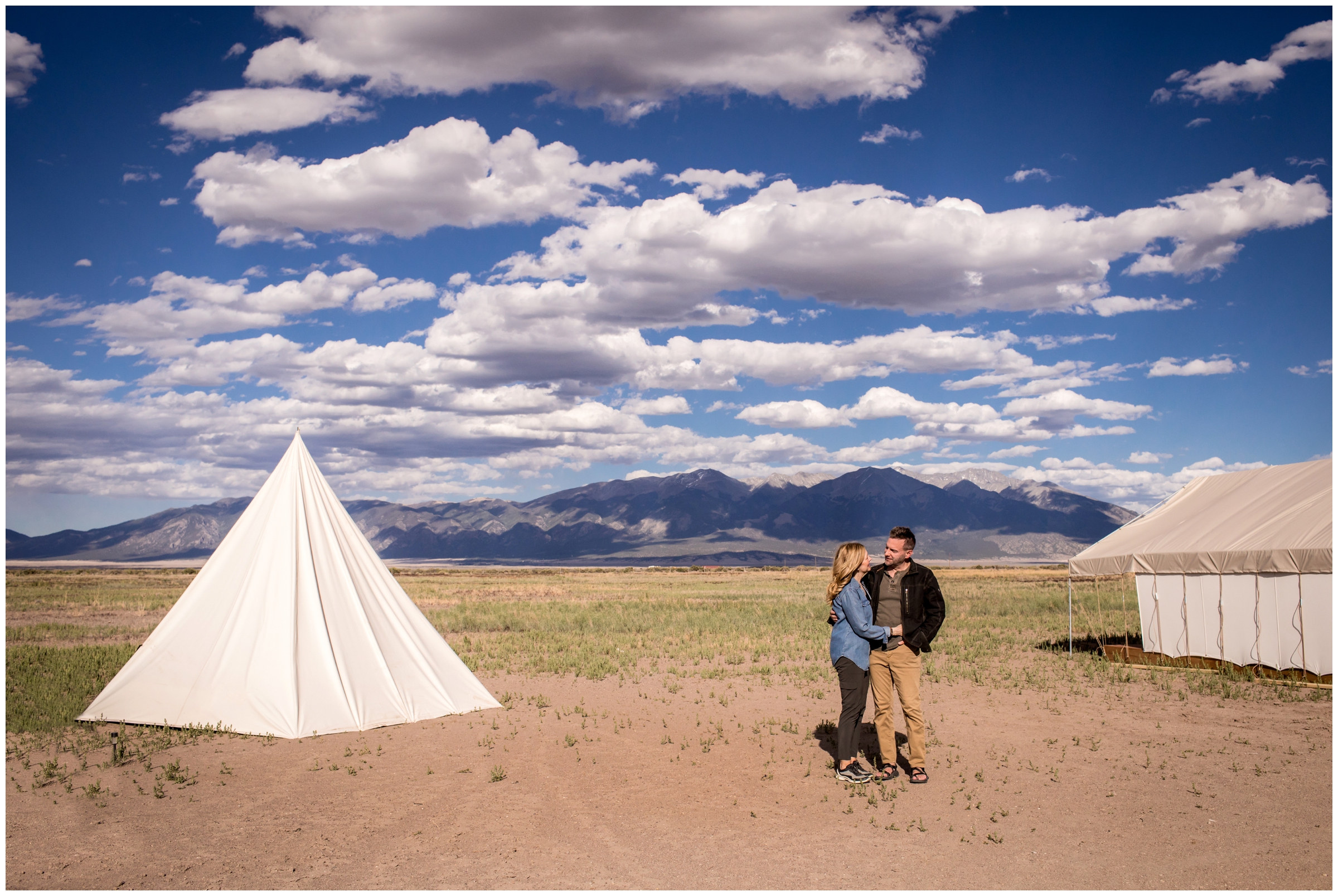 couple posing near teepee during Colorado camping engagement photos