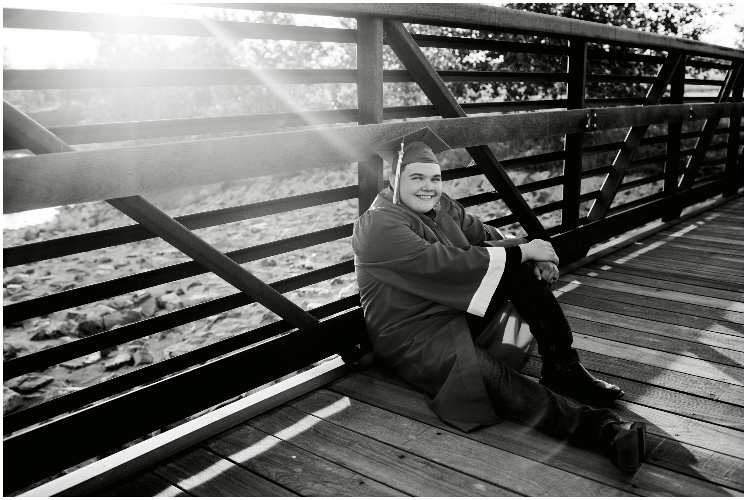 teen boy sitting on bridge during Erie Colorado graduation photos