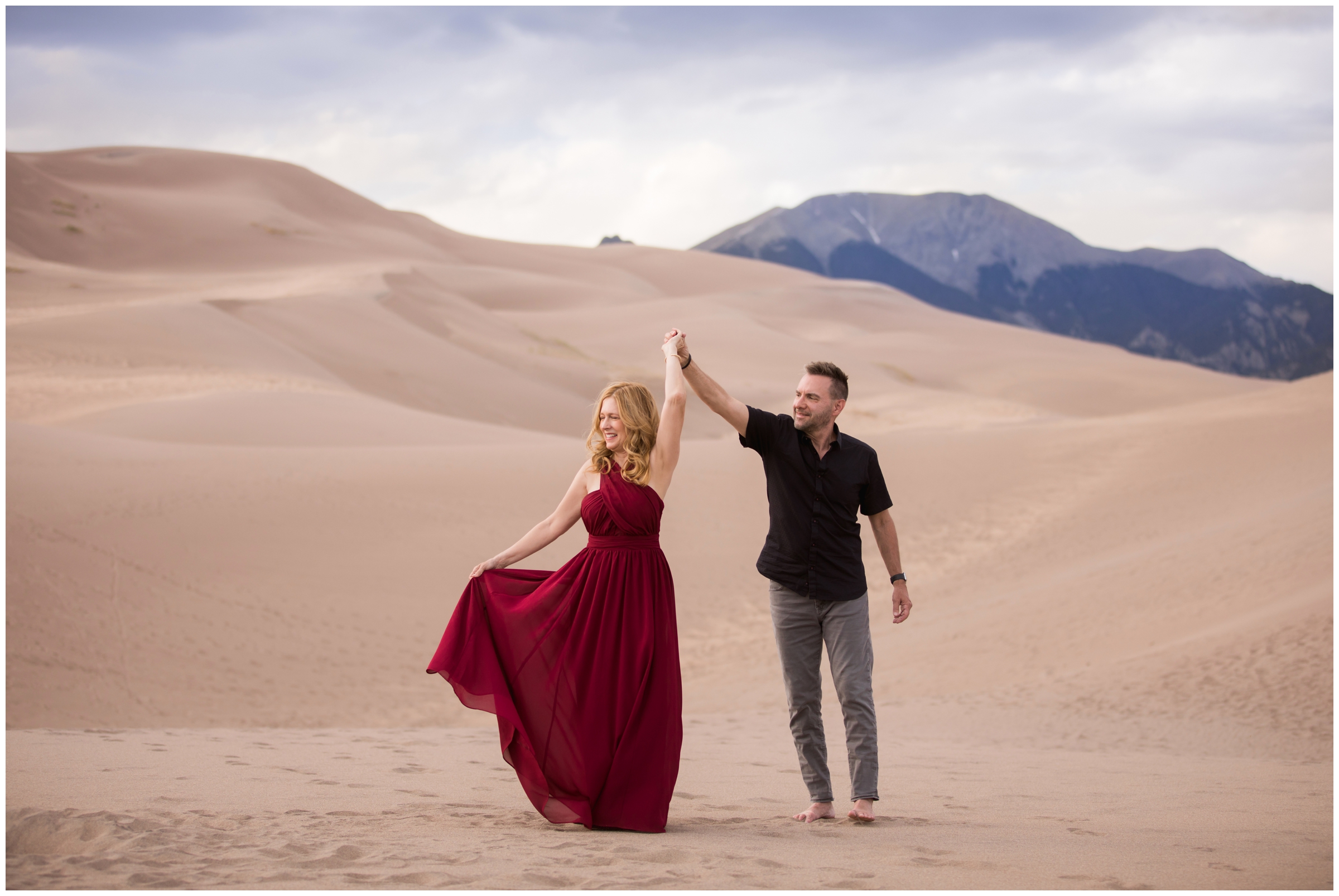 guy spinning wife at Great Sand Dunes colorado portrait photography session