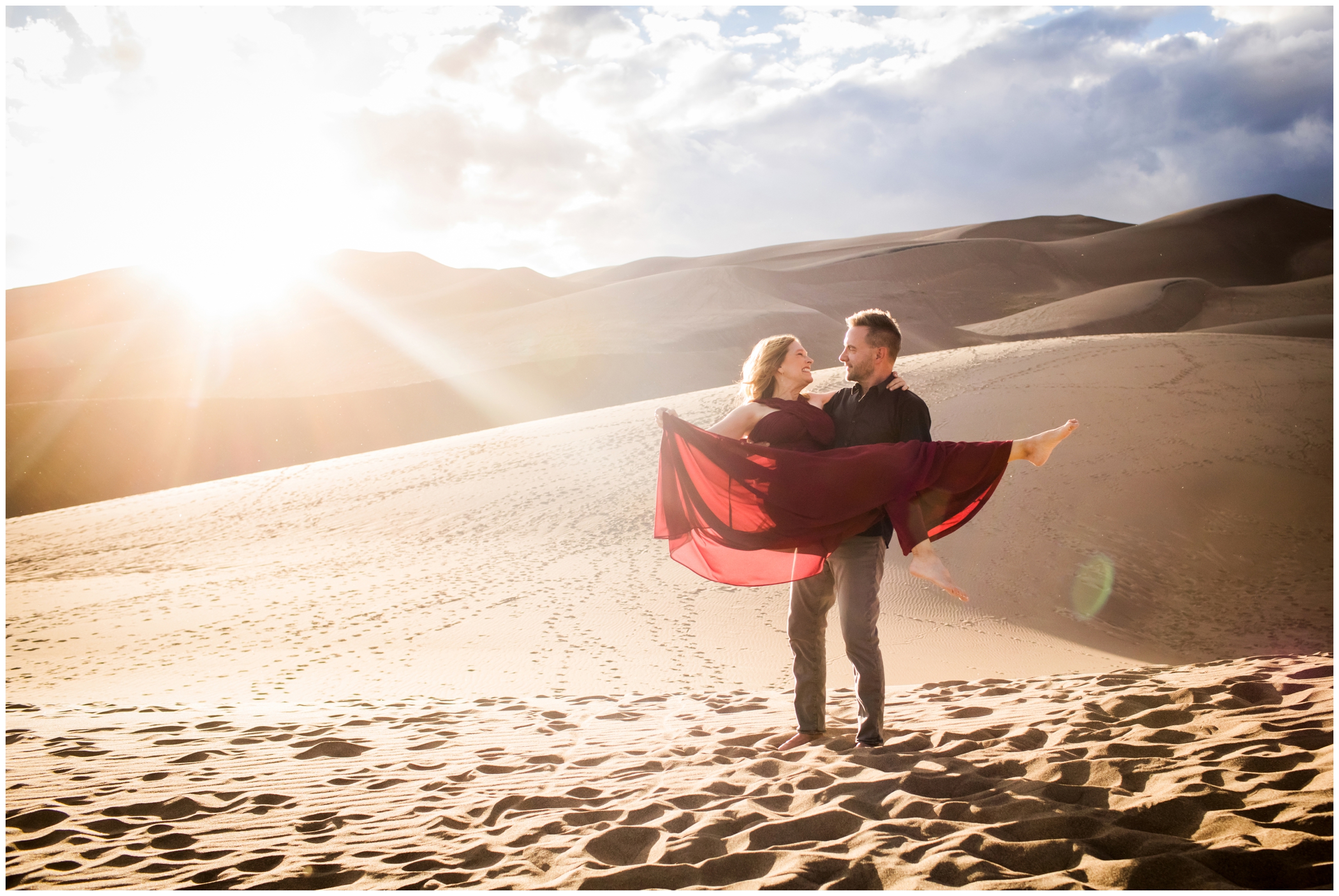 guy lifting wife at Great Sand Dunes National Park Colorado engagement couples photos