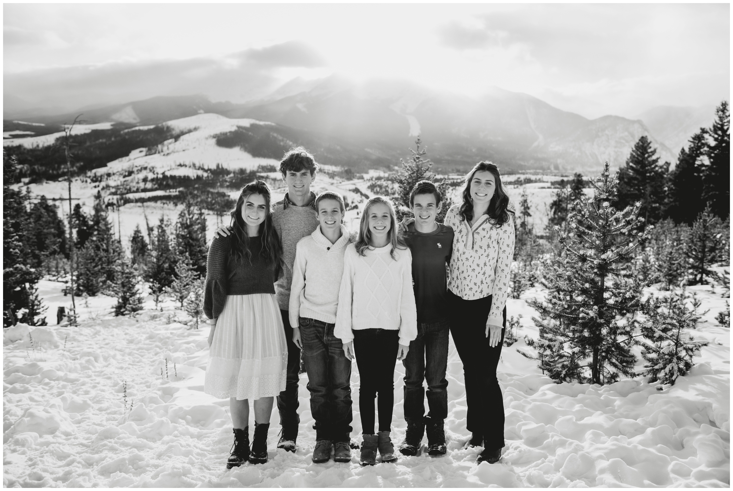 family of teen kids posing in the snow at Sapphire Point Overlook