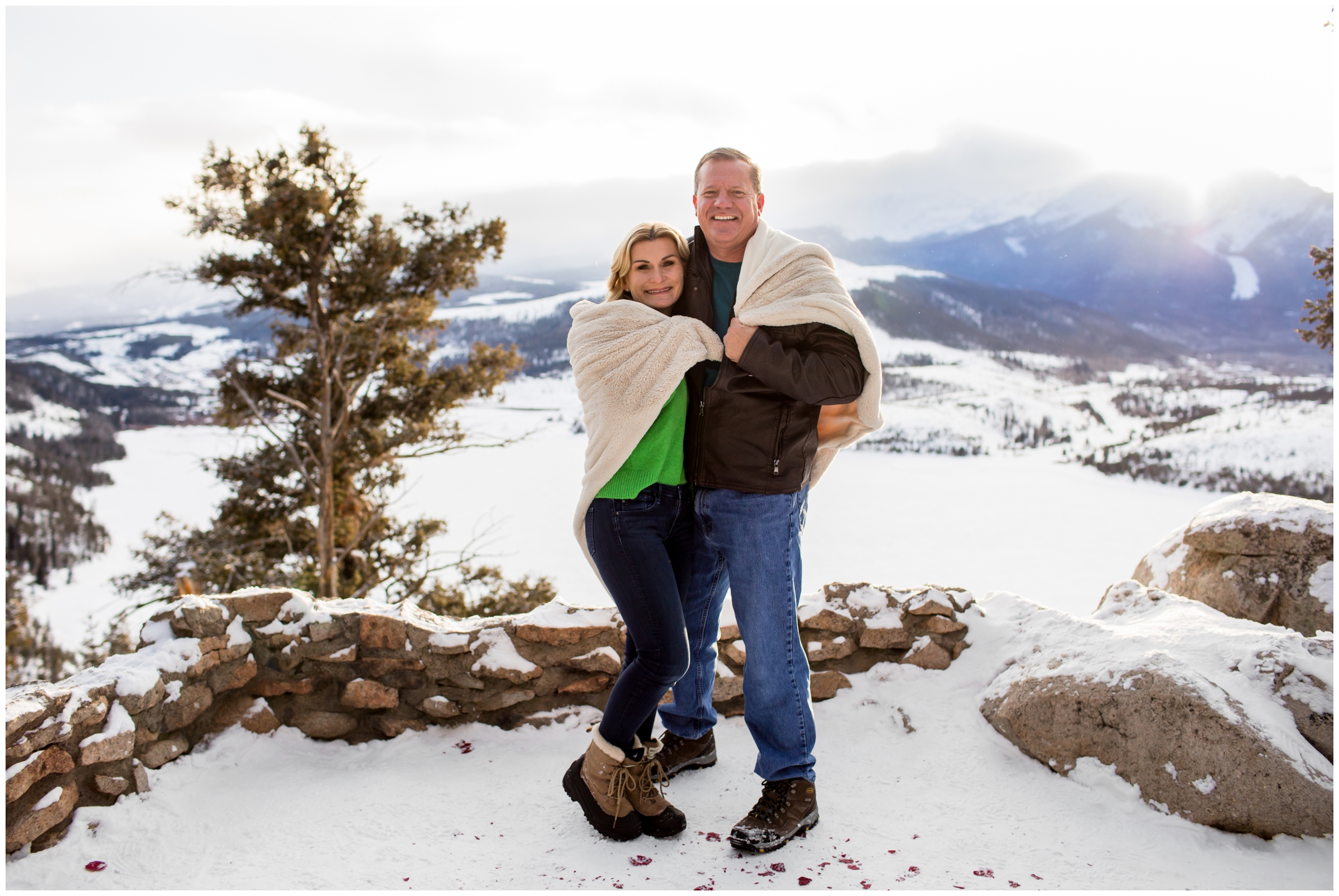 parents snuggling under a blanket at Breckenridge Colorado winter family photography session 