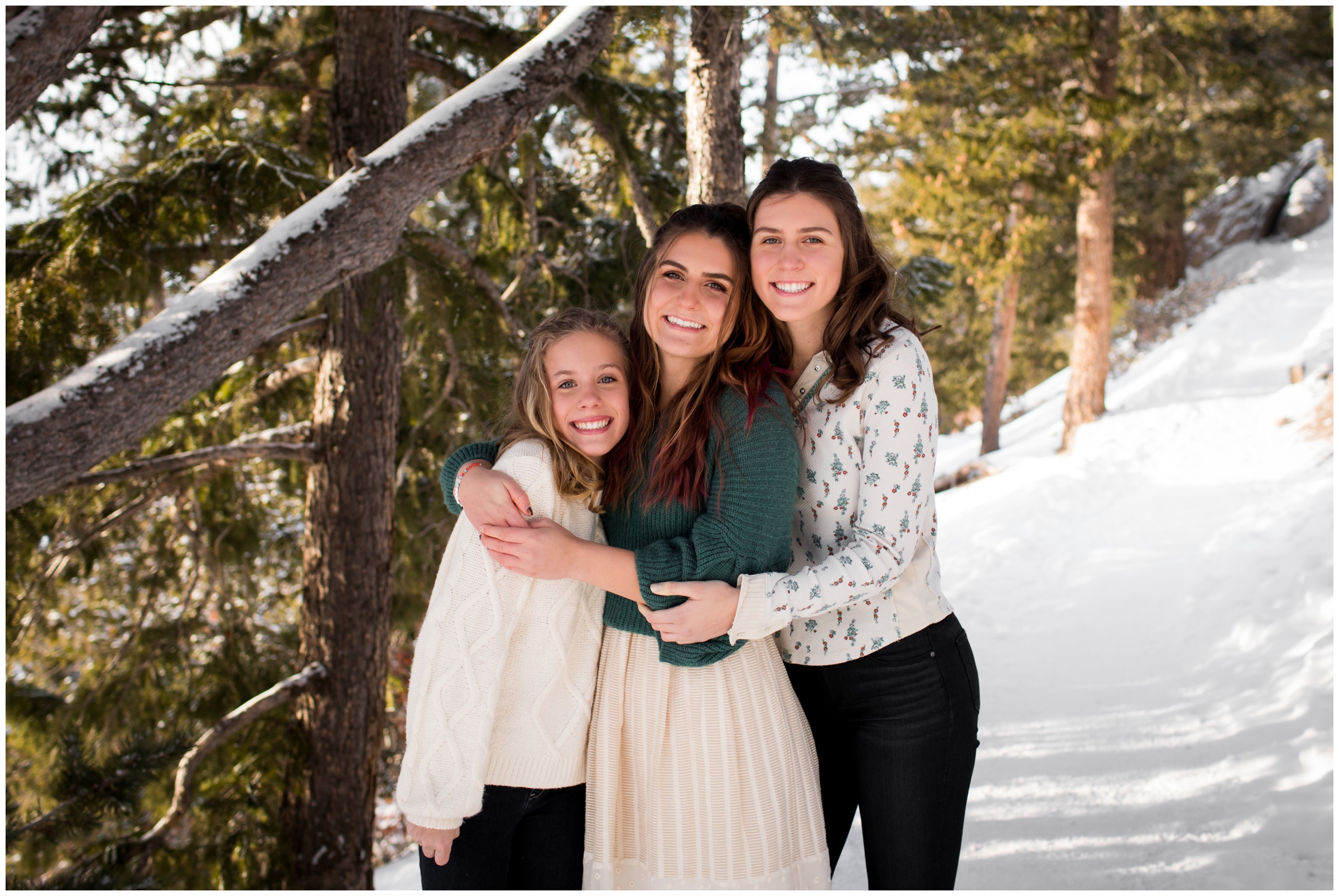 sisters hugging during snowy Colorado winter family pictures in Breckenridge Colorado 
