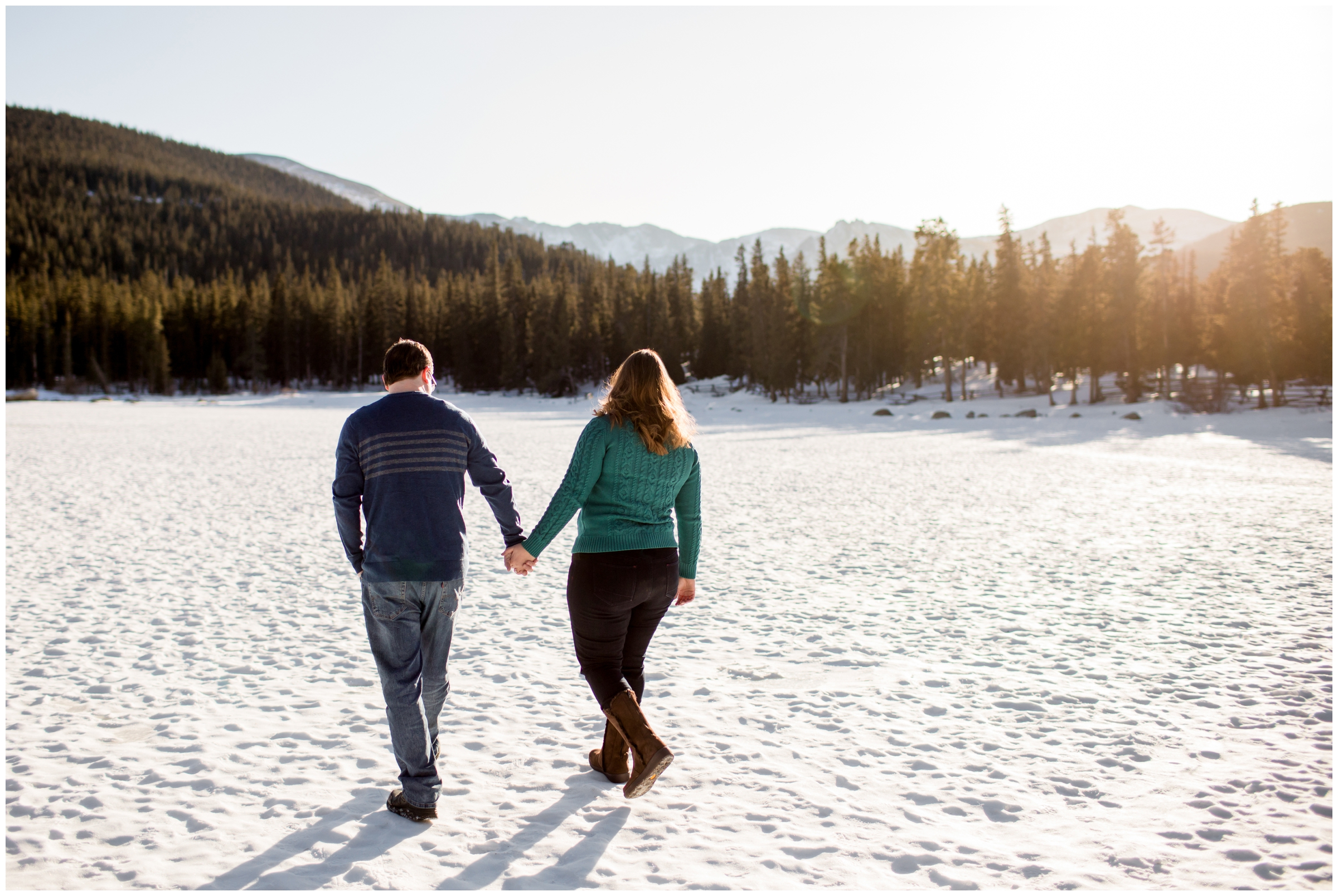 couple walking through the snow in Idaho Springs