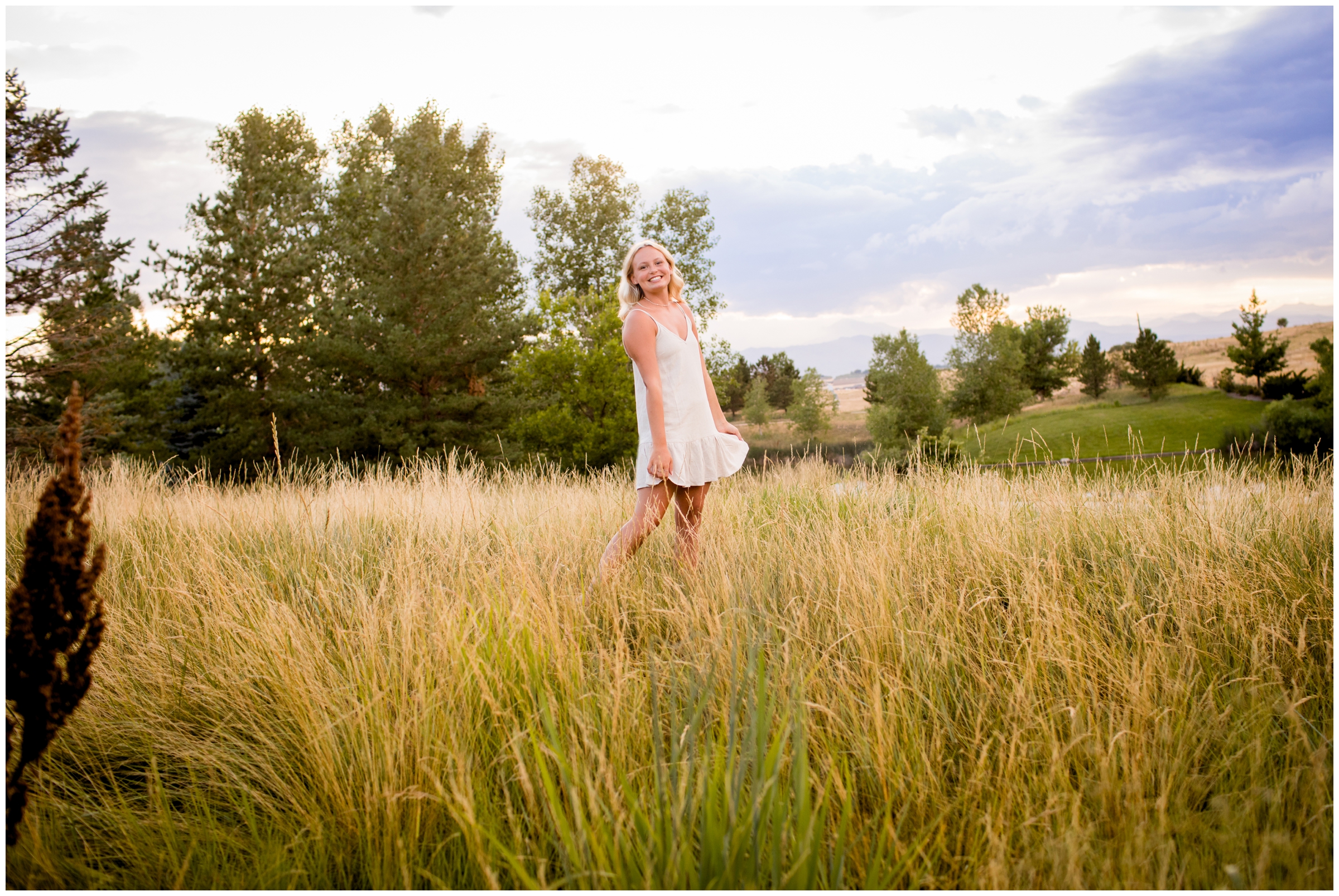 teen girl twirling in a field of long grasses in Colorado 