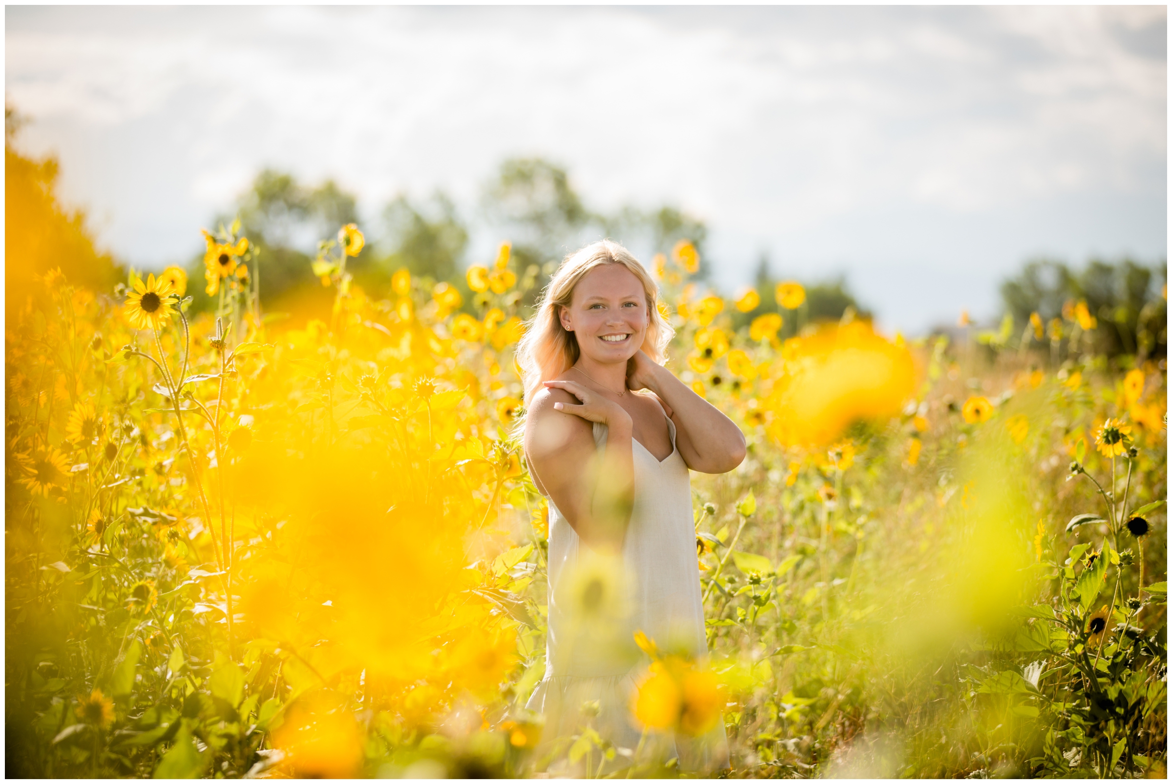 Erie senior portraits in a sunflower field by Northern Colorado photographer Plum Pretty Photography