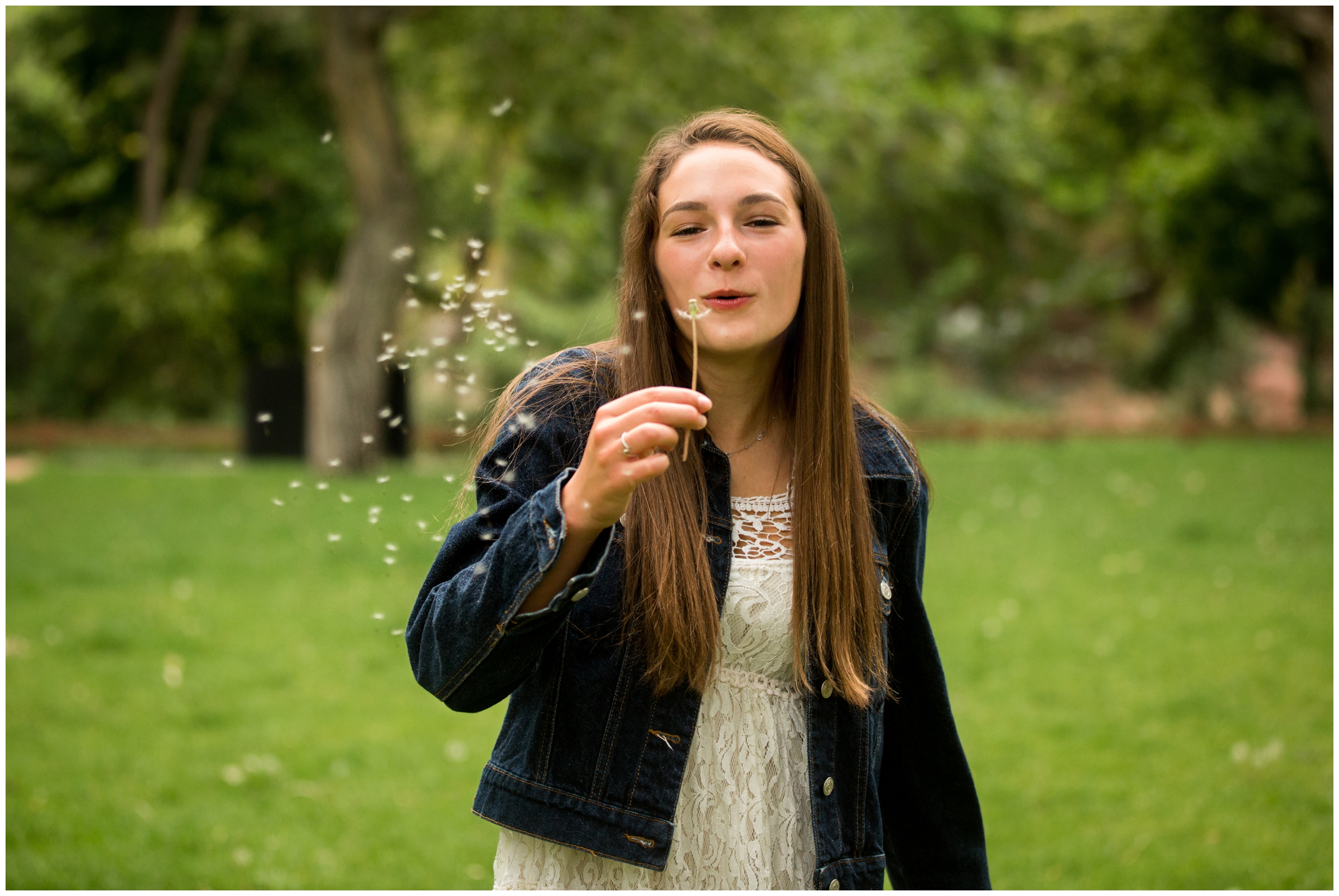 teen girl blowing dandelion during Lyons Colorado senior photos 