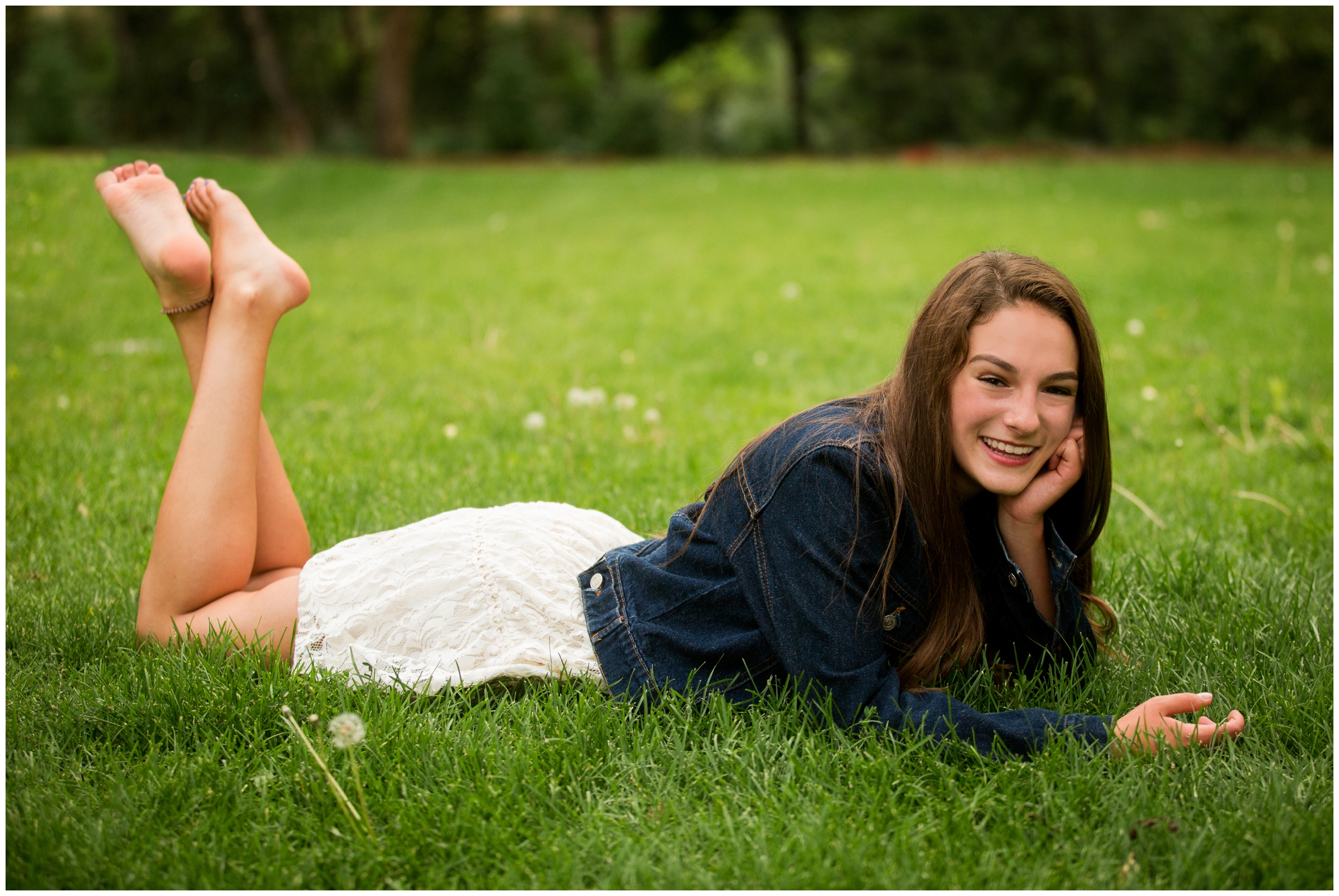 teen girl laying in grass during Colorado senior portraits by lyons photographer Plum Pretty Photography 