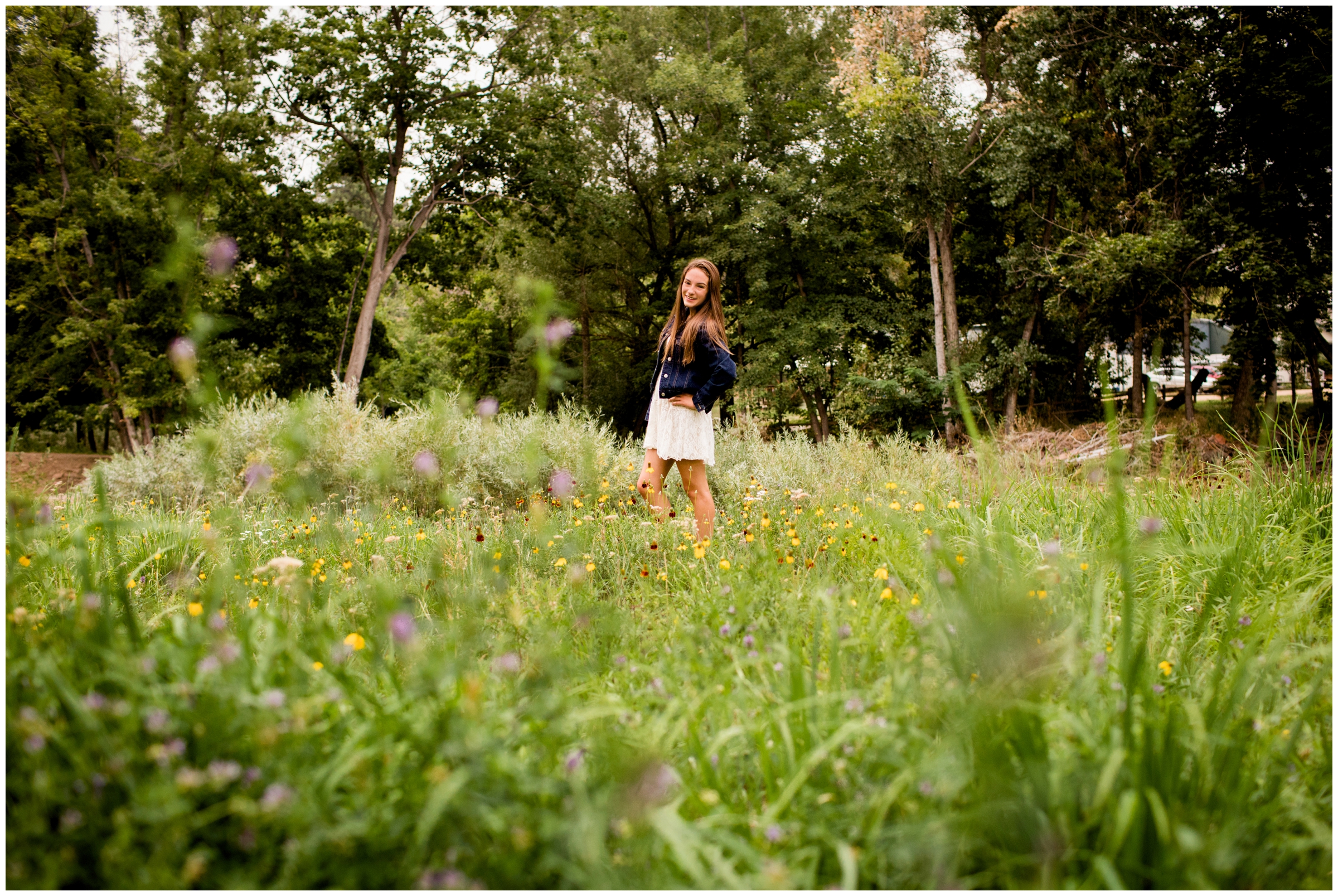teen posing in wildflowers during Colorado senior pictures in Lyons