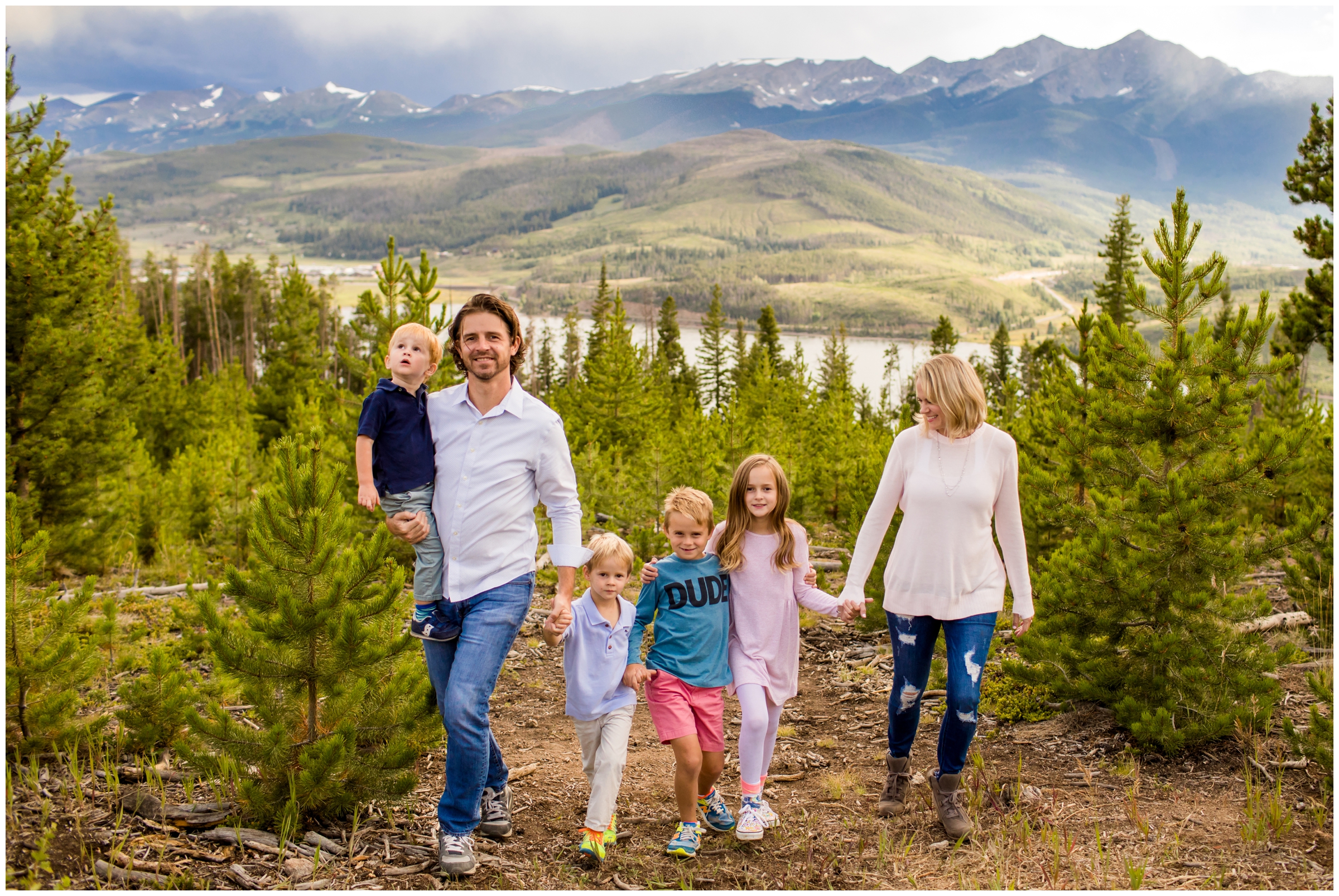family holding hands and walking during Breckenridge family photography session 