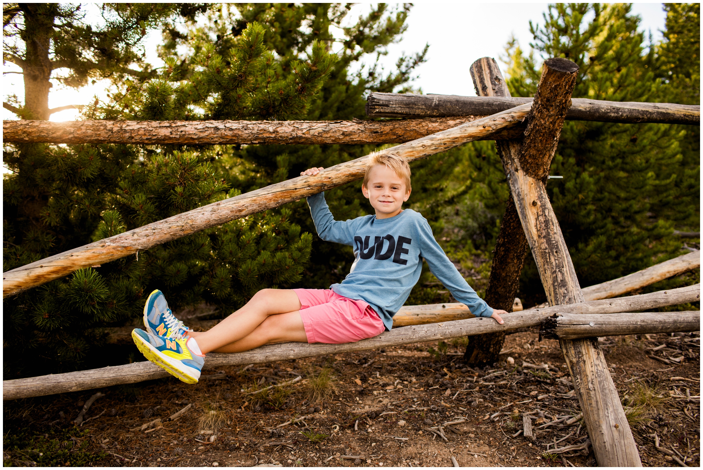 Little boy sitting on fence during Colorado family photography session in Breckenridge 