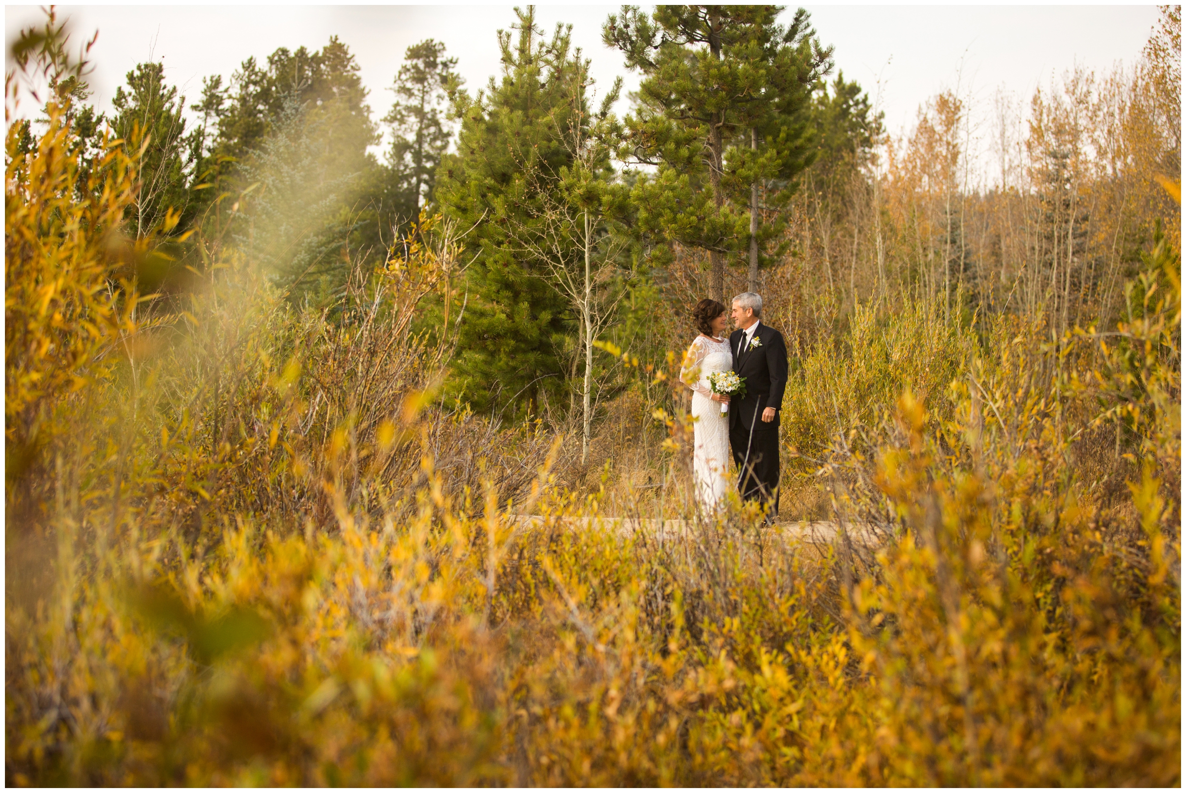 couple posing in fall foliage during Colorado mountain elopement portraits 