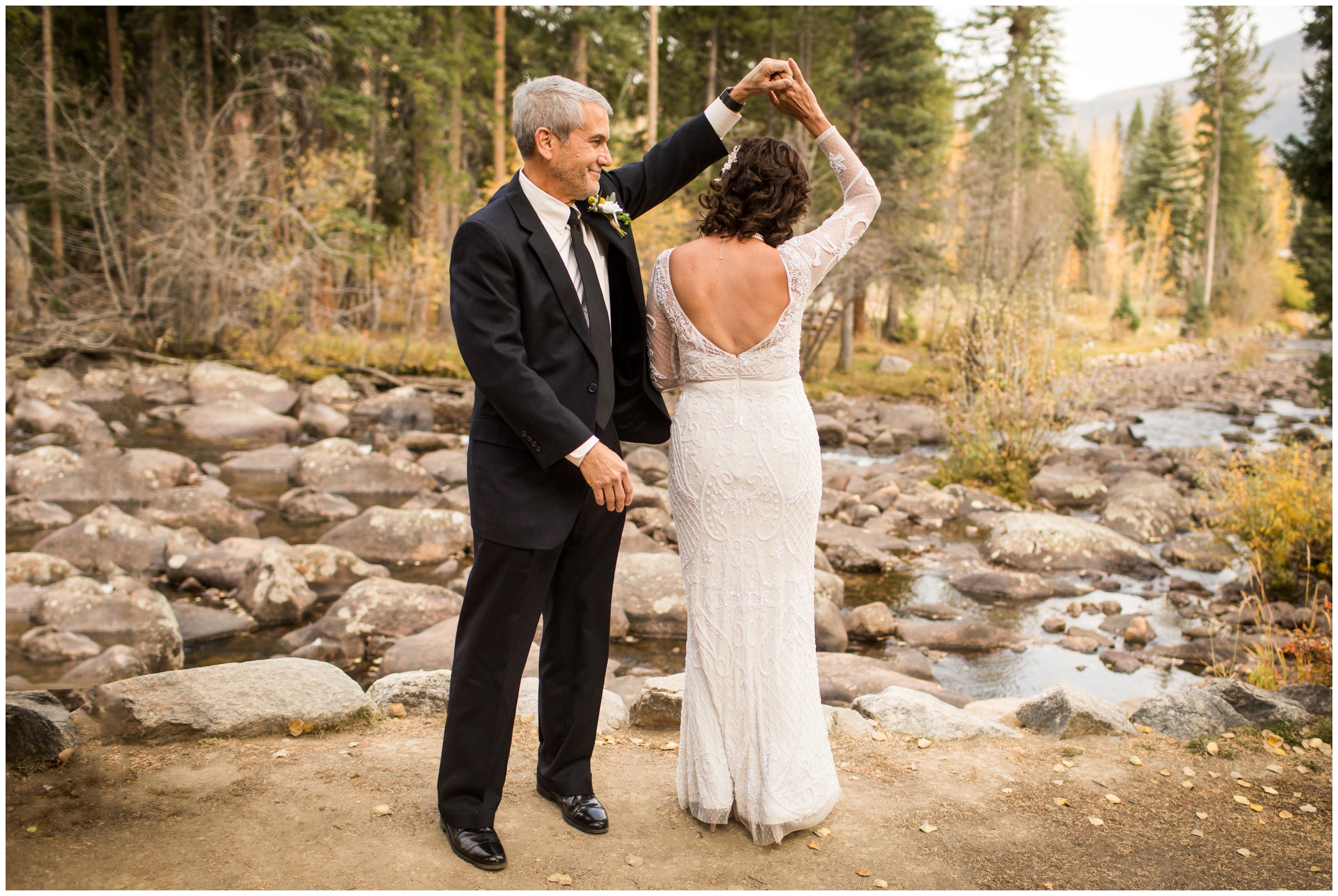 couple dancing with mountain river in background during Grand Lake elopement