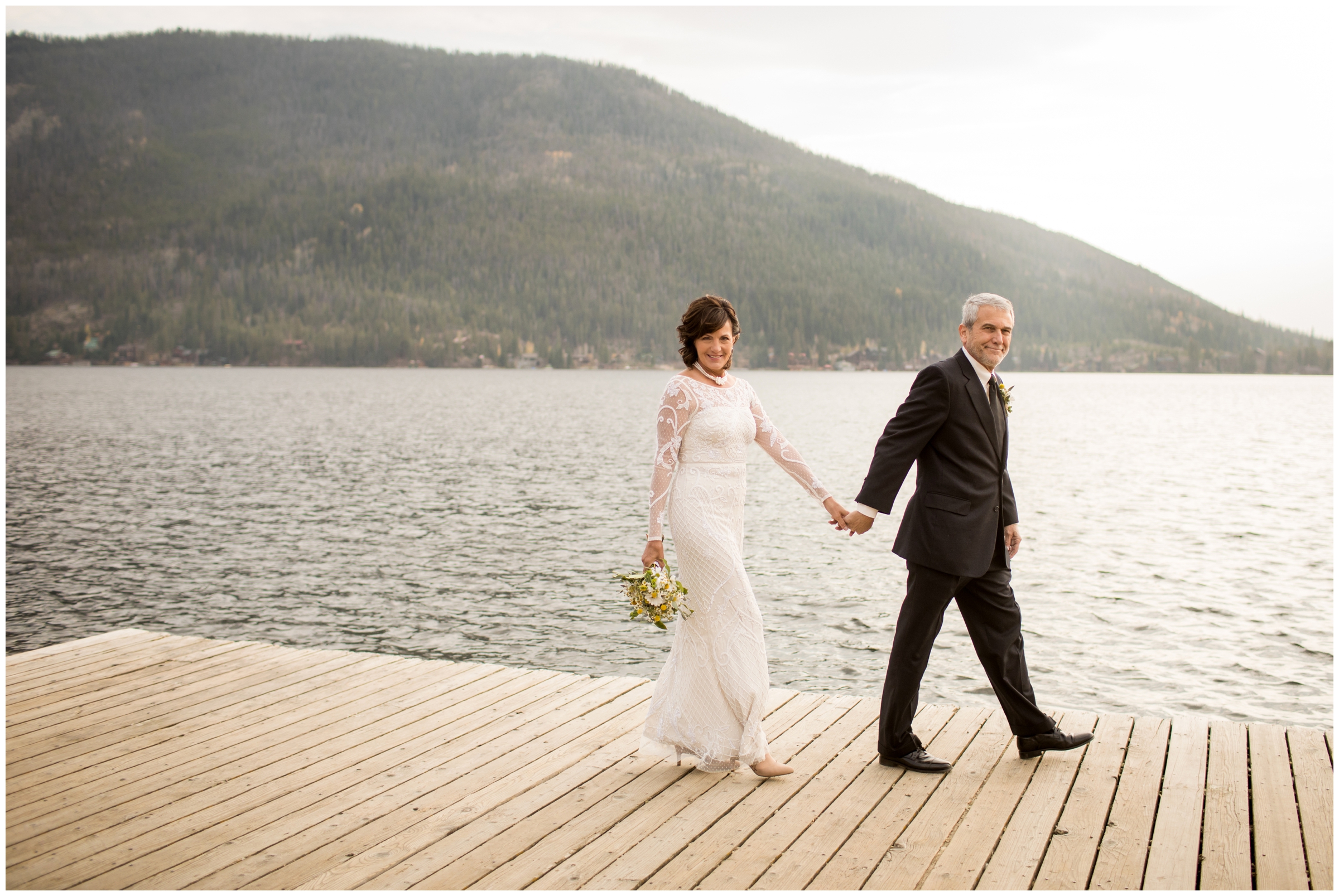 couple walking on boat dock at Grand Lake wedding 