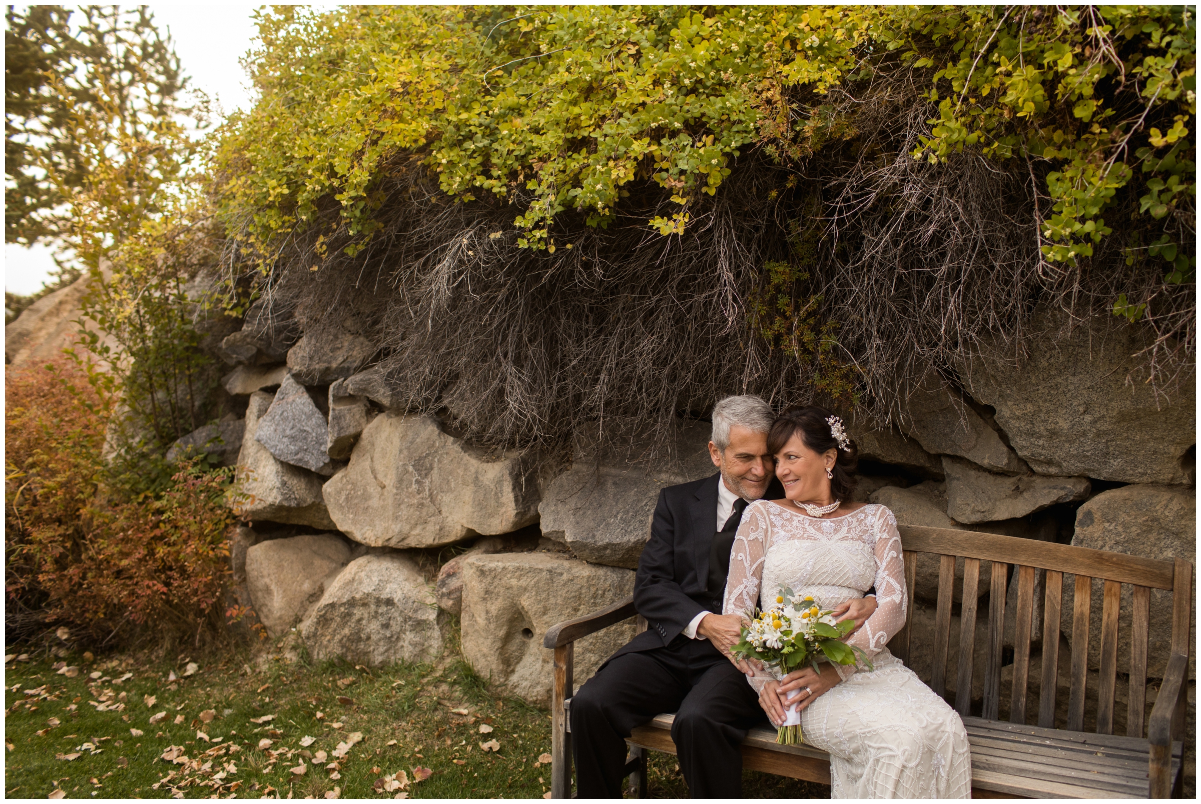 couple snuggling on a bench in Grand Lake during elopement portraits 