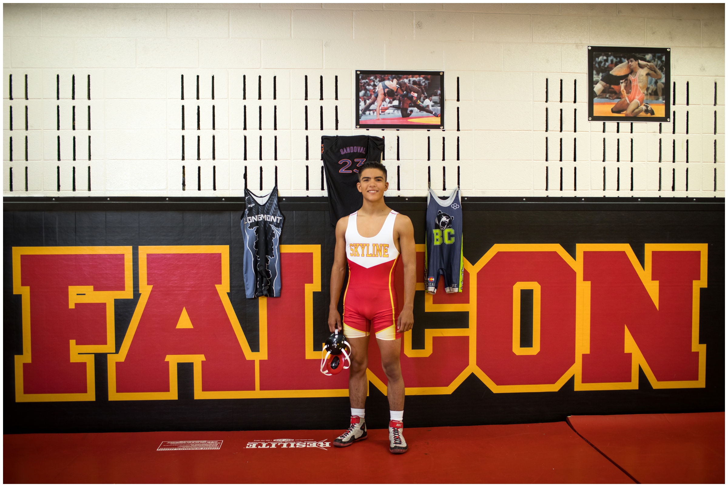 Skyline High School Colorado wrestler posing in wrestling room during Longmont senior pictures 