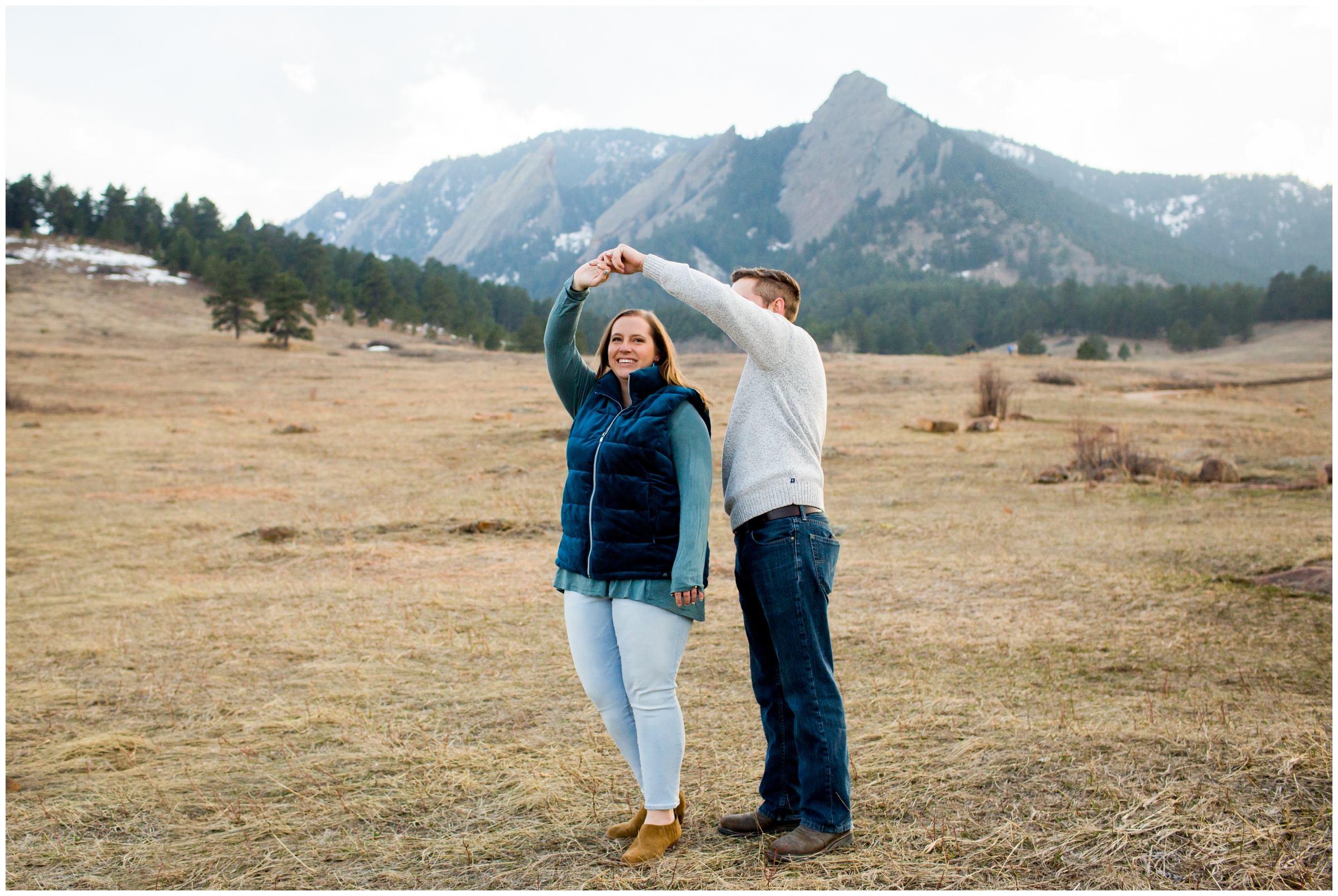 couple dancing in a field during Colorado engagement photos at Chautauqua Park 