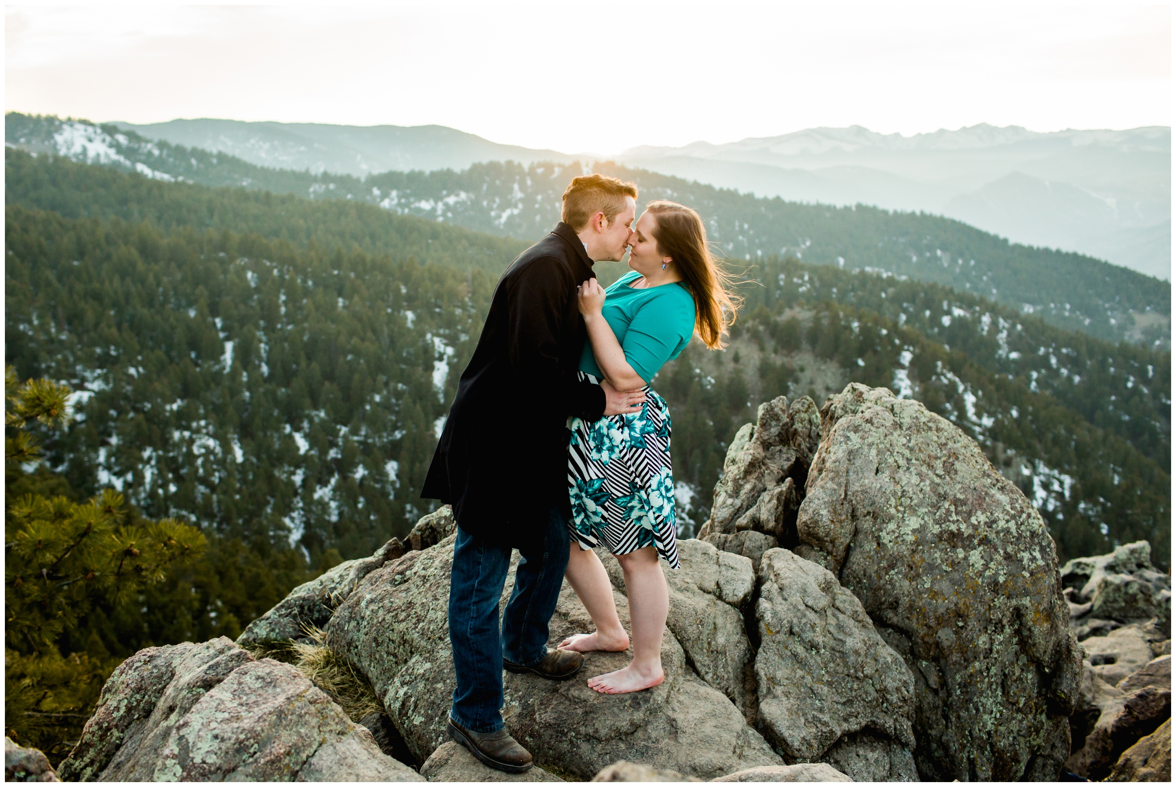 couple kissing at sunset with mountains in background at Lost Gulch Overlook Boulder