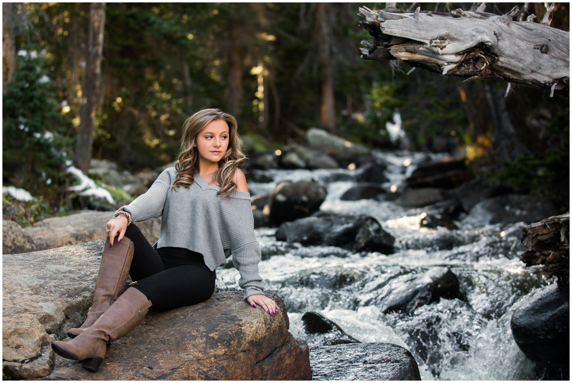 teen girl sitting next to river during Colorado graduation portraits 