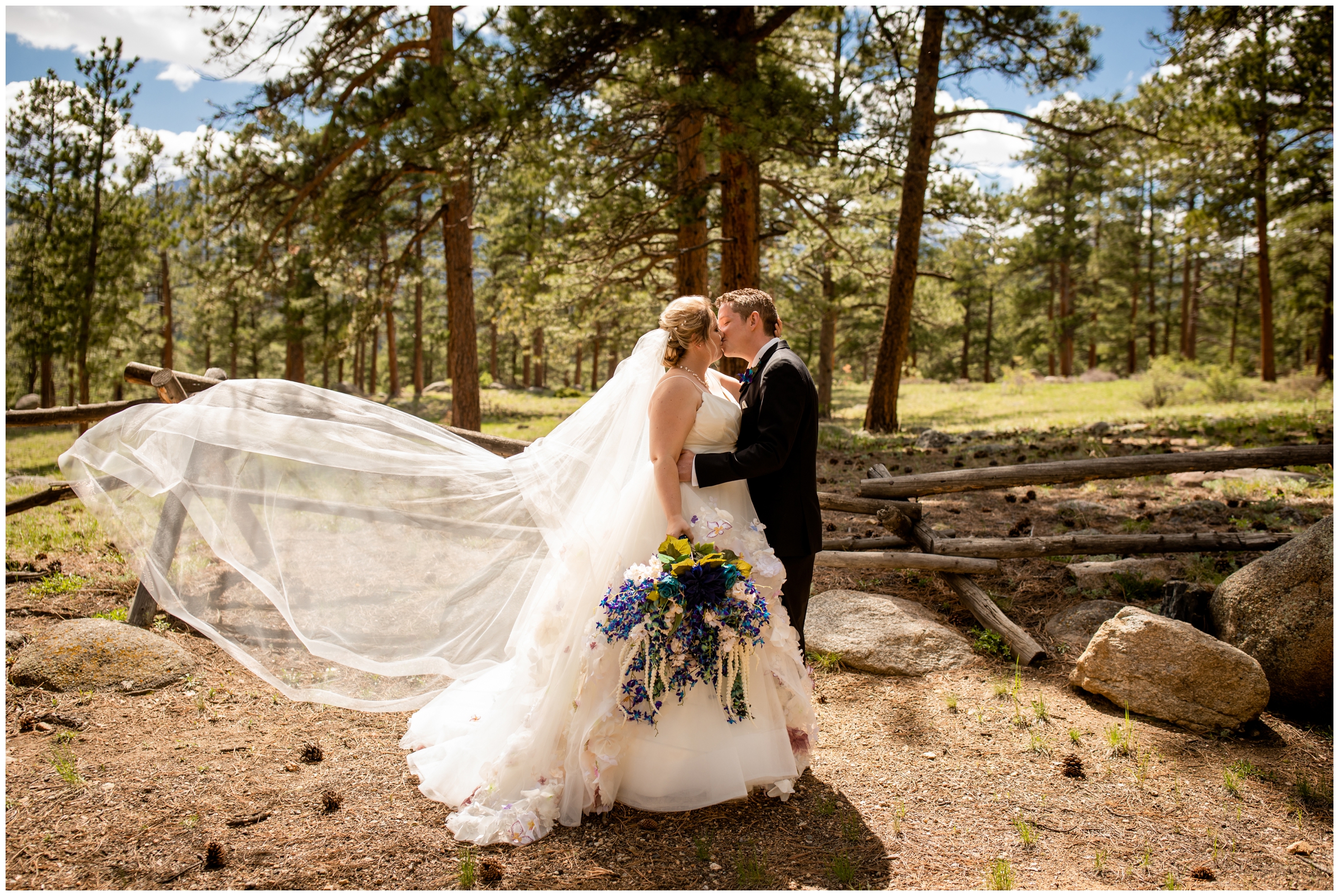 couple kissing and veil flying during Della Terra wedding photography in Estes Park 