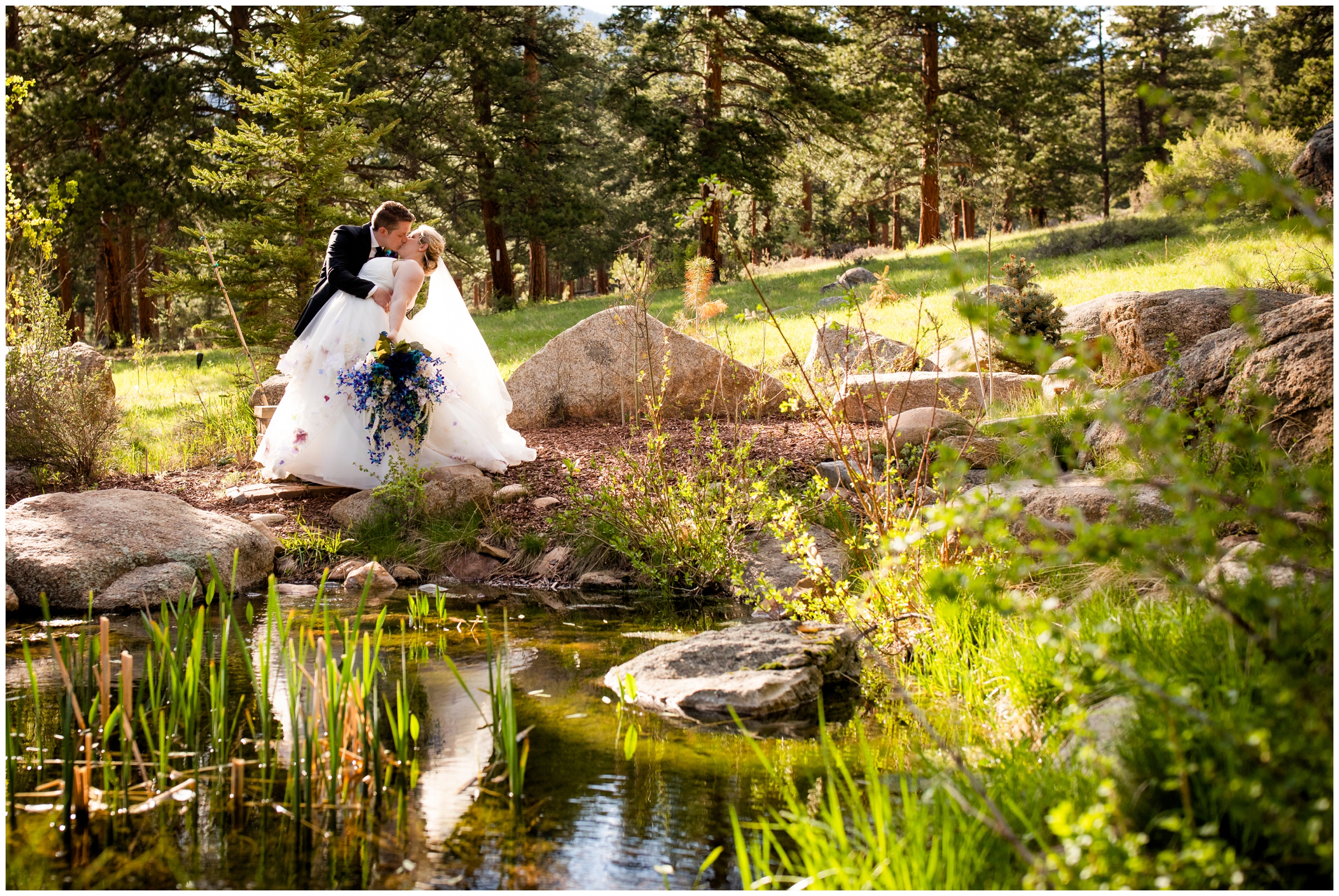 couple dipping near outdoor pond during Della Terra wedding photography in Estes Park 
