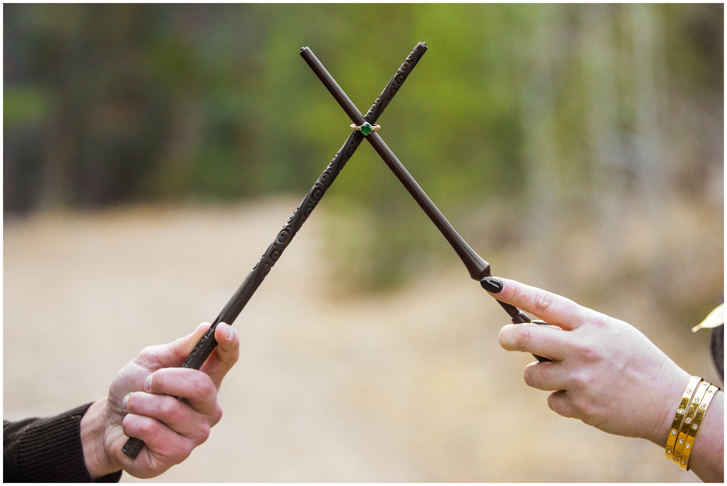 Engagement ring on wands during Harry Potter inspired engagement pictures 
