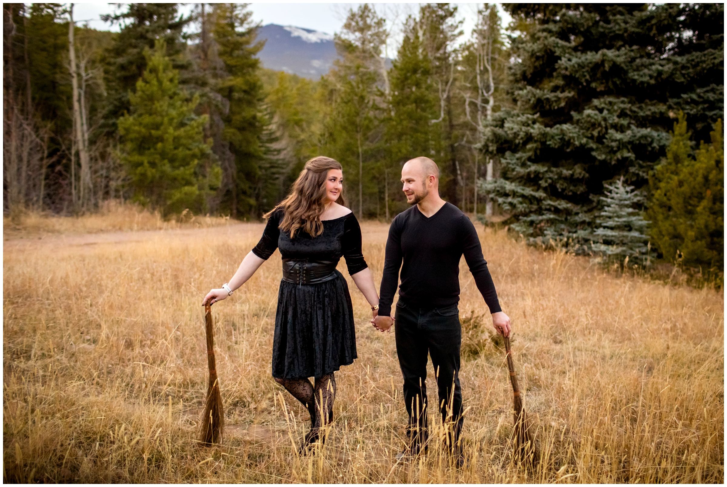 couple posing with broomsticks during Harry Potter engagement pictures in evergreen Colorado 