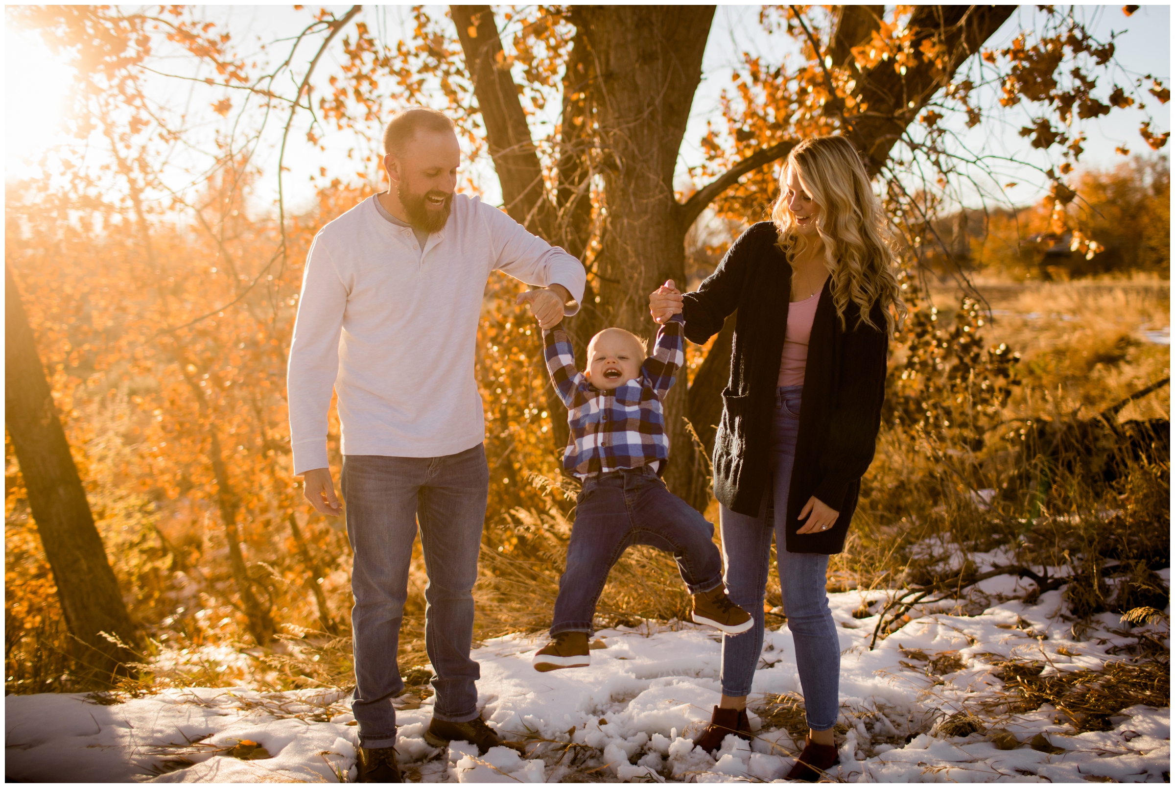 parents swinging son during Fort Collins family pictures at Riverbend Ponds