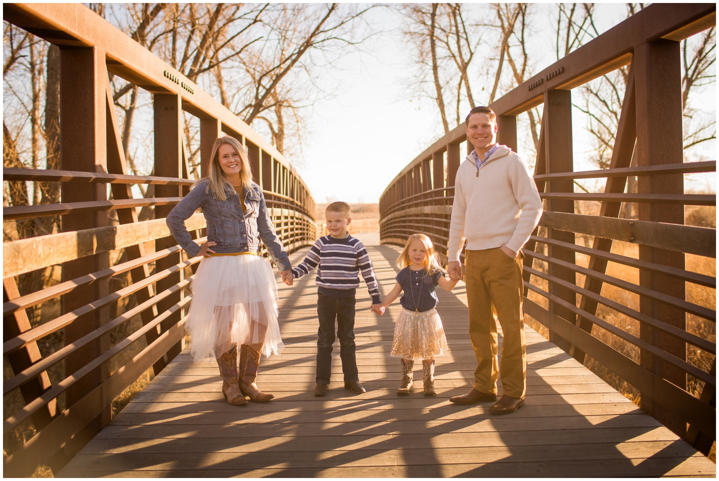 family posing on bridge at Sandstone Ranch during Longmont family photography mini session 