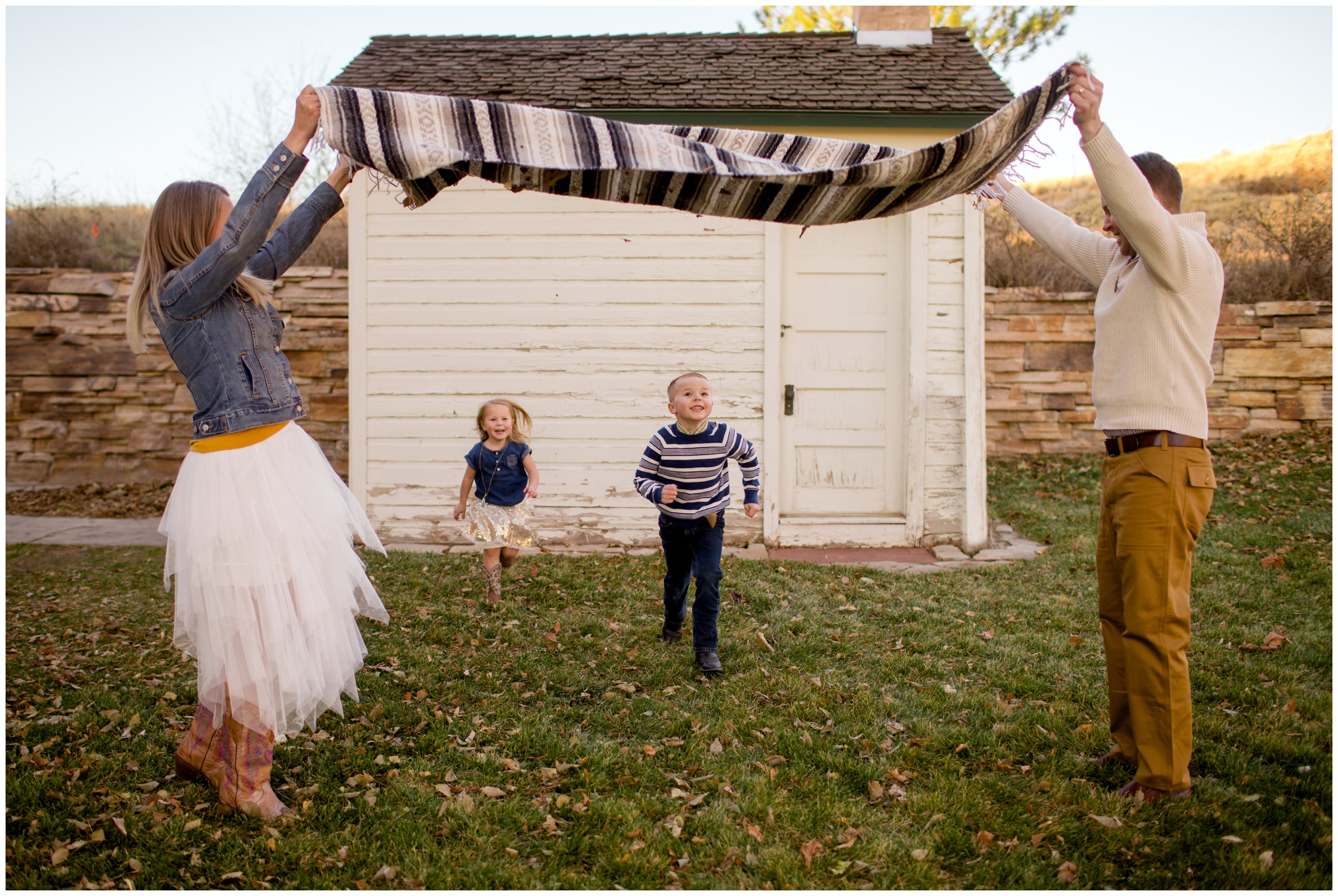 kids running under a blanker during candid fall family photography mini session in Longmont Colorado 