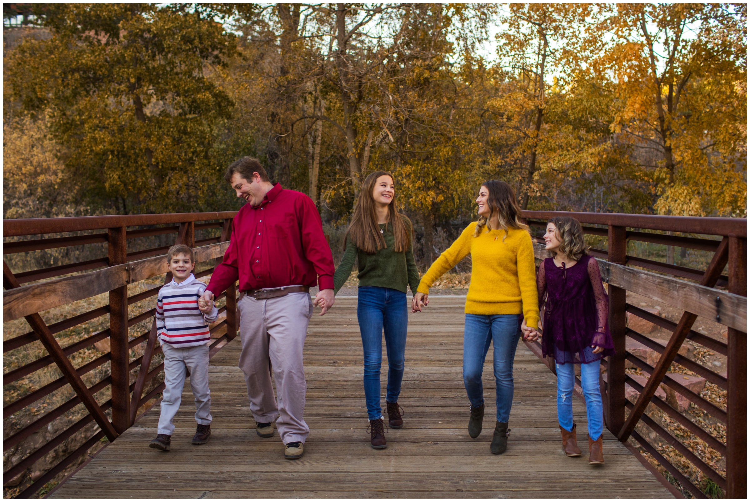 family walking on a bridge during Lyons Colorado family photos during fall  