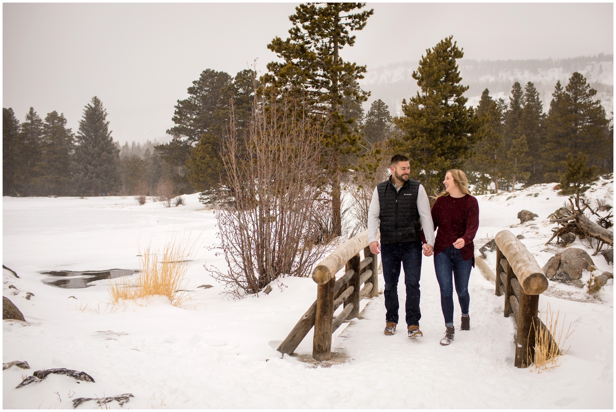 couple walking in the snow during Estes park engagement photography session 