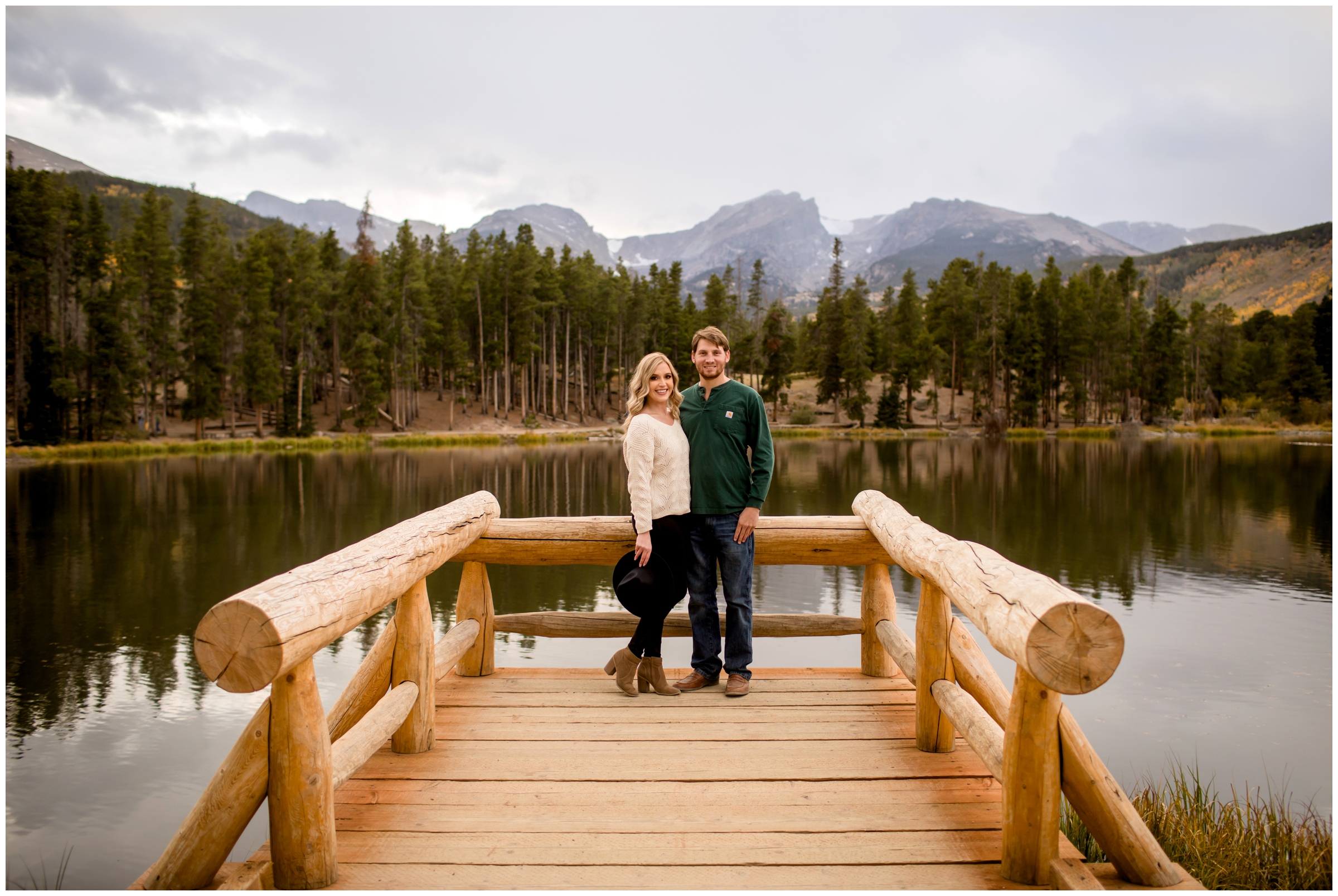 couple posing on dock at Sprague Lake during Estes park portraits 