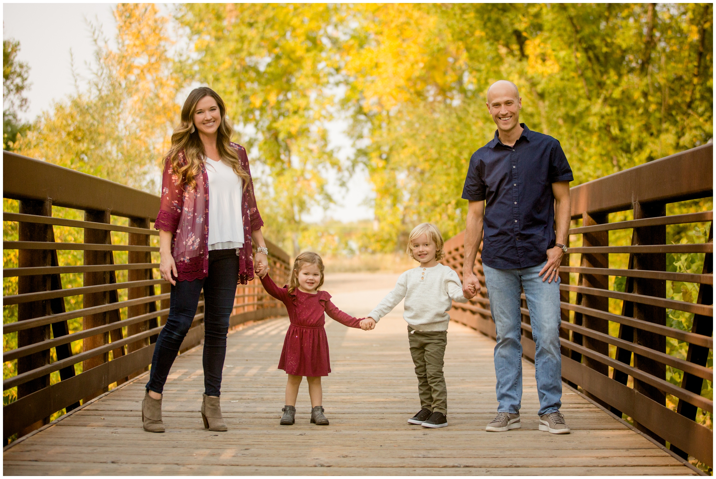 family posing on bridge during fall family pictures in Longmont 