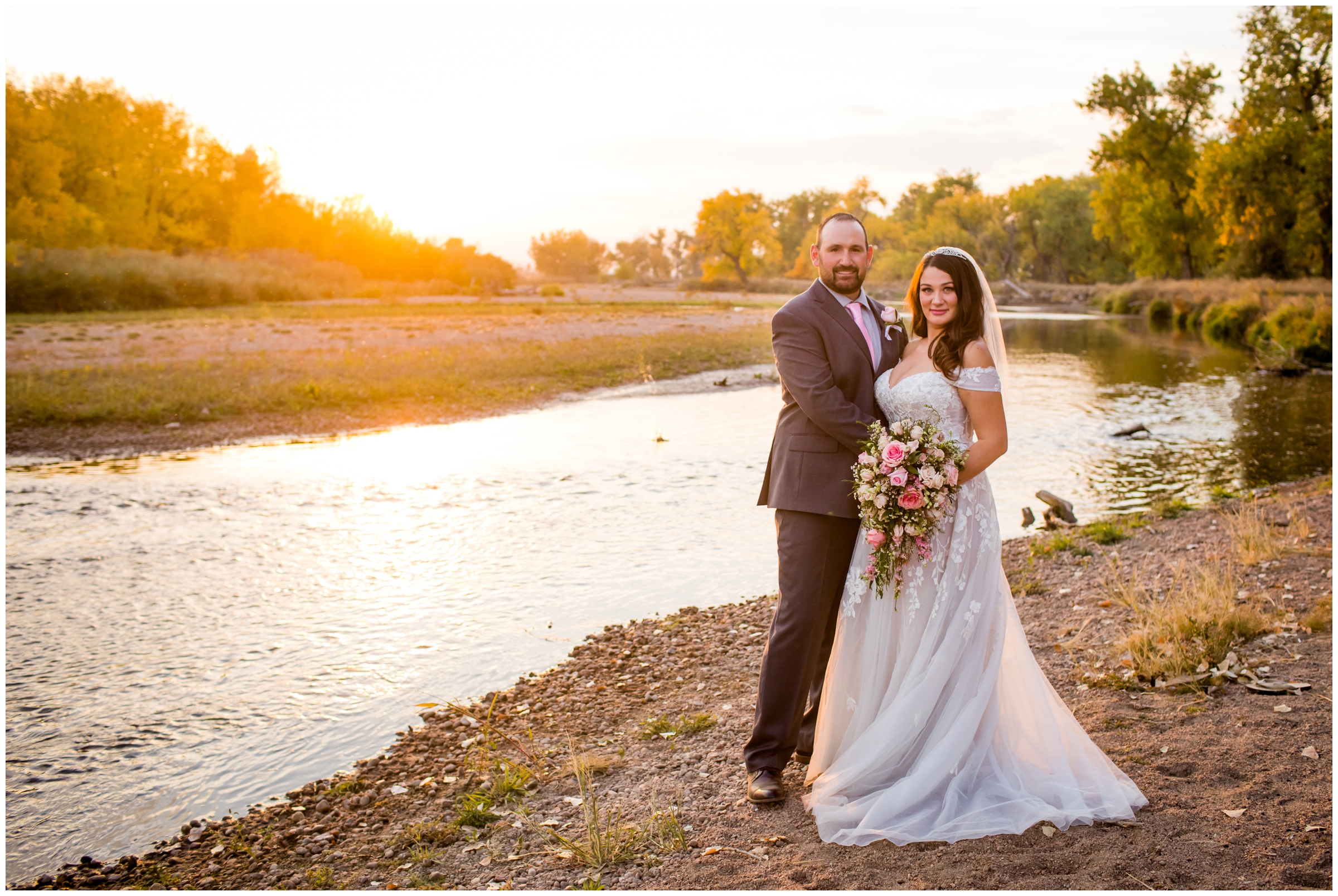bride and groom posing next to the river during Platteville Colorado wedding photography 
