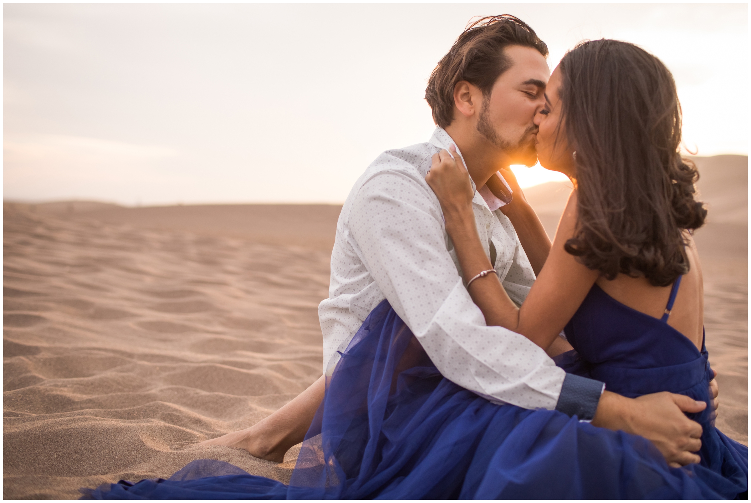 couple kissing in the sand during Great Sand Dunes Colorado engagement couples photography 