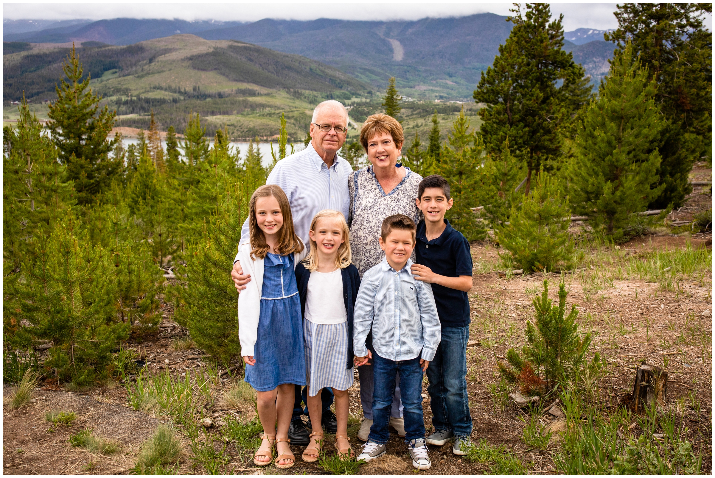 grandparents and grandchildren posing with mountains in background during Colorado extended family photos 